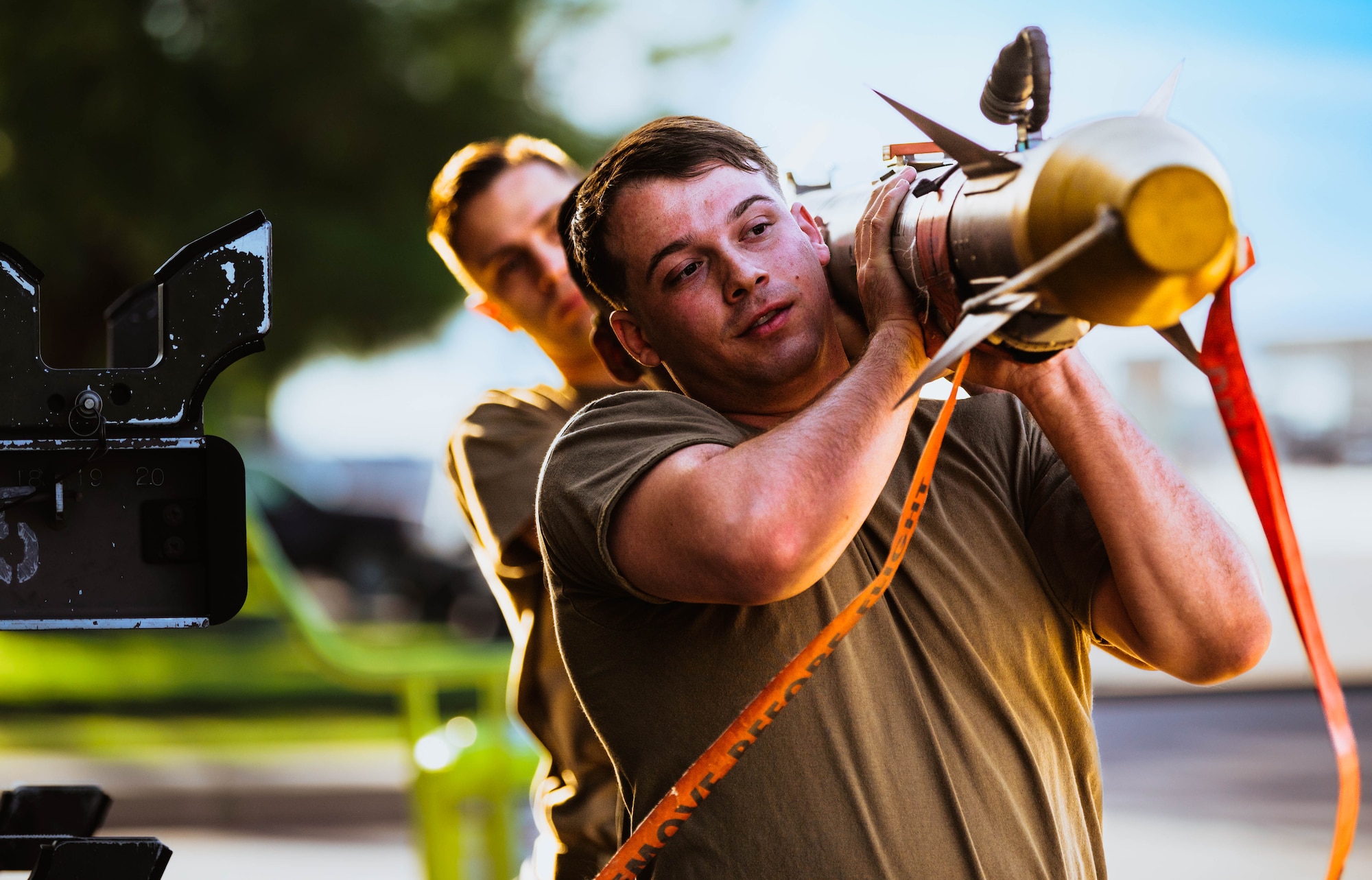 U.S. Air Force Senior Airman Jacob Schweigart, 309th Aircraft Maintenance Unit weapons load crew member, helps prepare a GBU-12 Paveway II bomb for a U.S. Air Force F-35A Lightning II during the third quarterly weapons load competition.