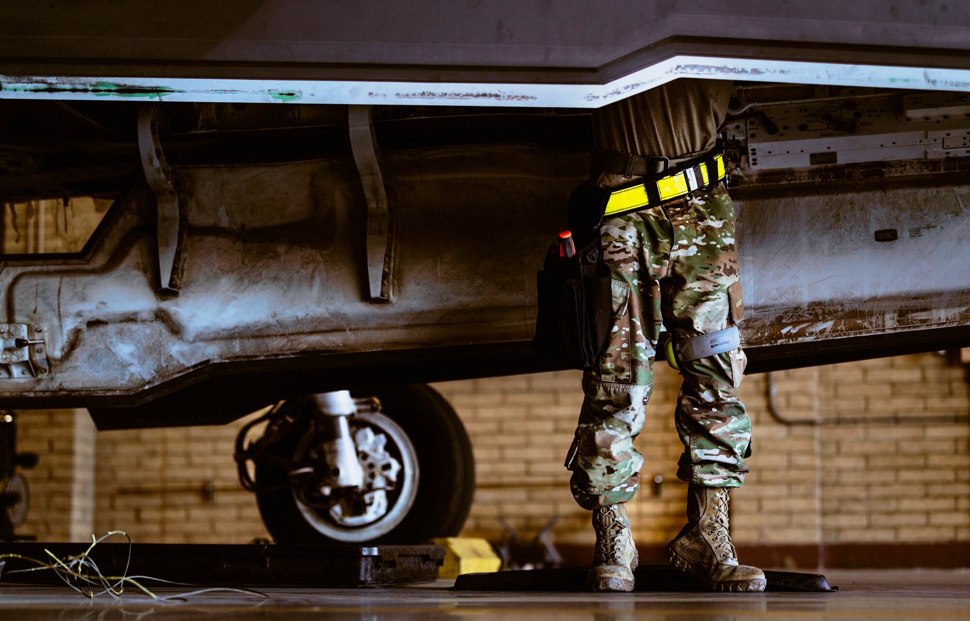 A U.S. Air Force 63rd Aircraft Maintenance Unit weapons load crew member helps prepare a GBU-12 Paveway II bomb for a U.S. Air Force F-35A Lightning II during the third quarterly weapons load competition.