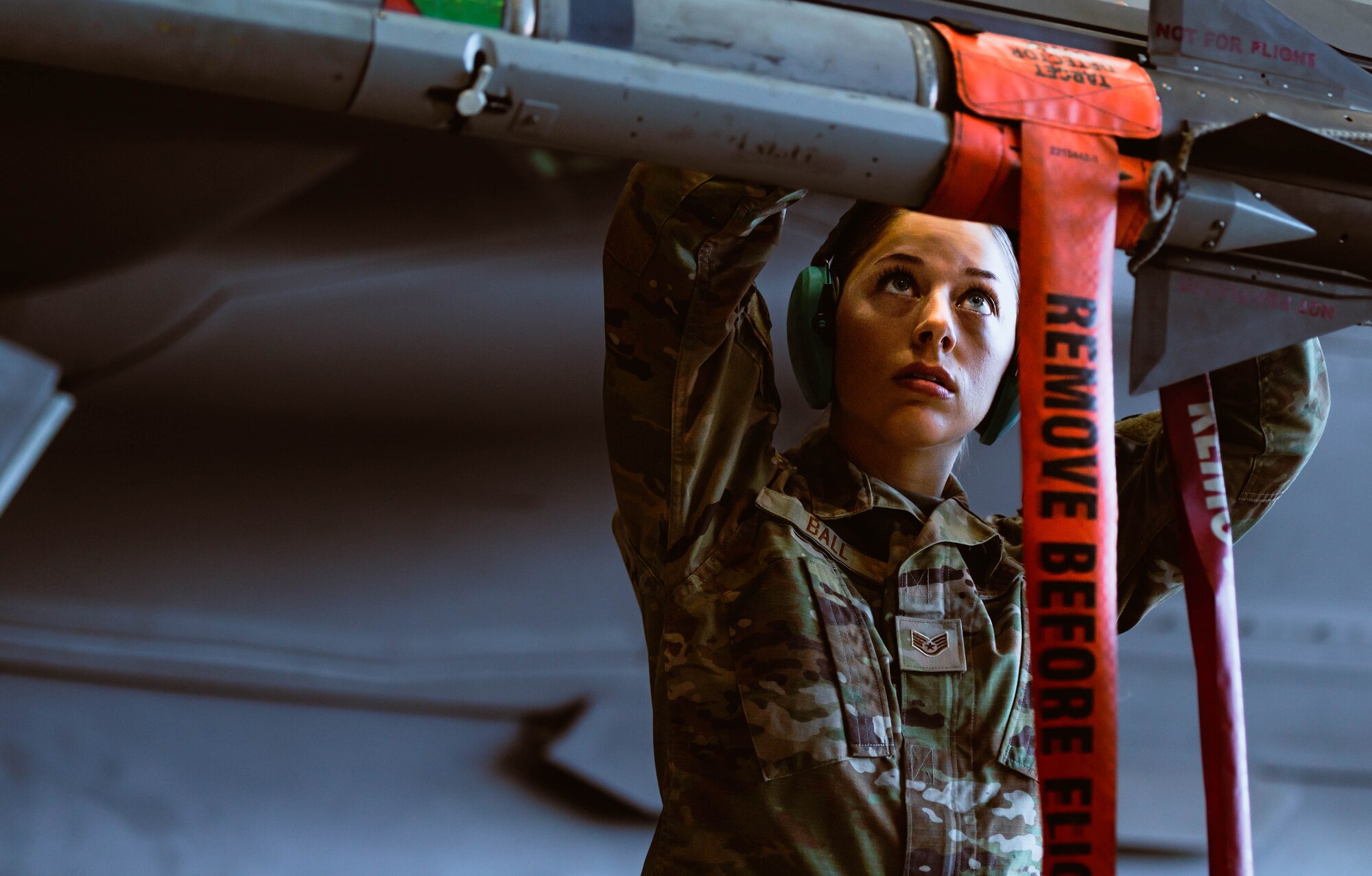 U.S. Air Force Staff Sgt. Quinn Ball, 56th Maintenance Group weapons load crew member, secures an AIM-9X Sidewinder missile for a U.S. Air Force F-35A Lightning II during the third quarterly weapons load competition.