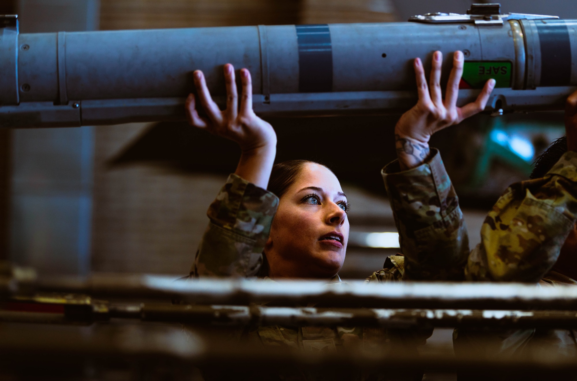 U.S. Air Force Staff Sgt. Quinn Ball, 56th Maintenance Group weapons load crew member, secures an AIM-9X Sidewinder missile for a U.S. Air Force F-35A Lightning II during the third quarterly weapons load competition.