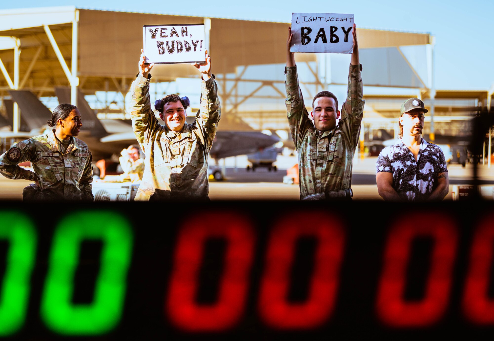 U.S. Air Force Airmen from the 56th Fighter Wing cheer on weapons load crew members during the third quarterly weapons load competition.