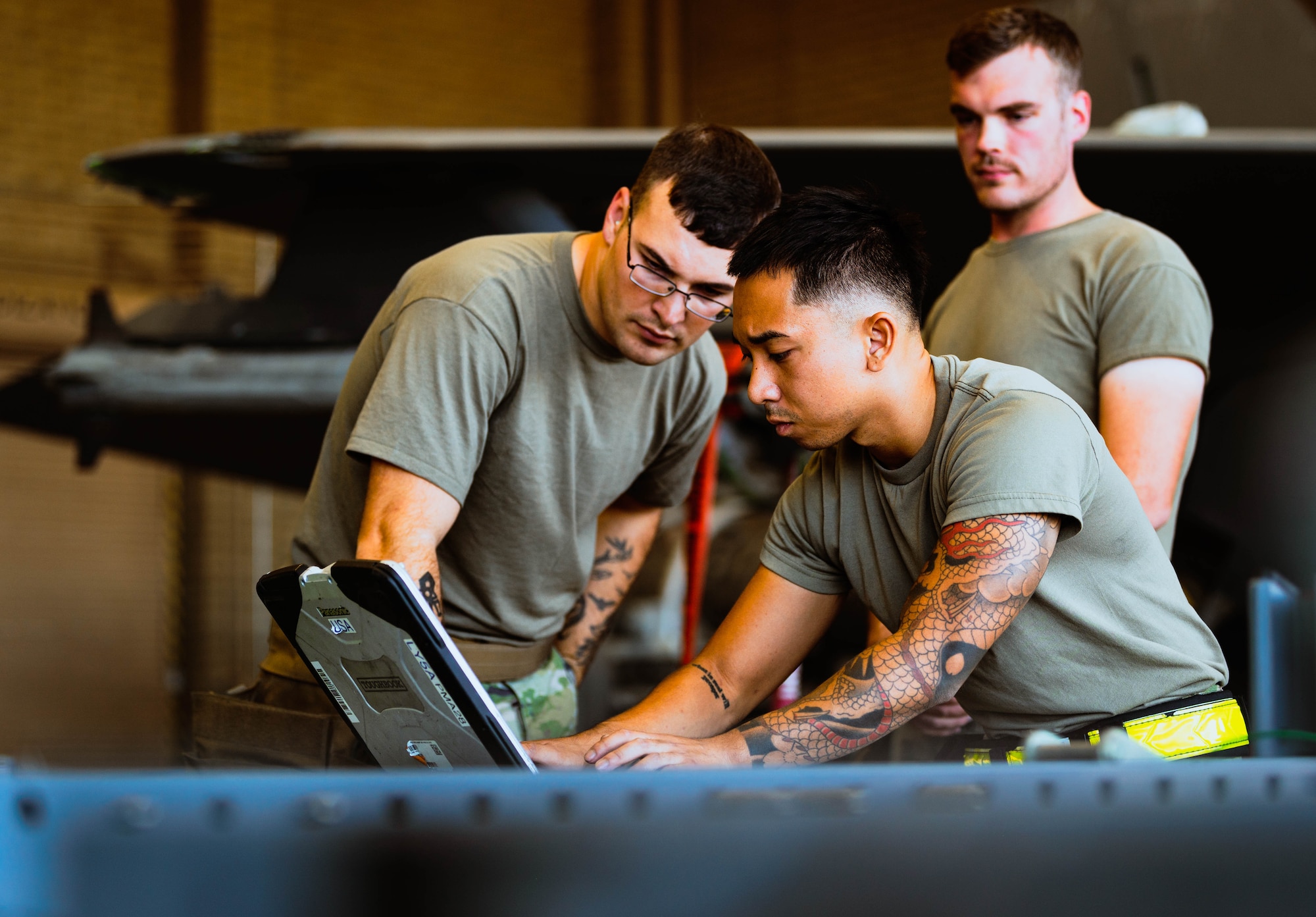 U.S. Air Force Senior Airman Alexander Peterson (left), Staff Sgt. Paolo Silva (front), and Senior Airman Aaron Vind (back), 63rd Aircraft Maintenance Unit weapons load crew members, help prepare a GBU-12 Paveway II bomb for a U.S. Air Force F-35A Lightning II during the third quarterly weapons load competition.