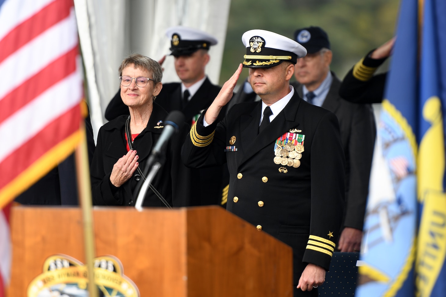 Cmdr. Matthew Beach, commanding officer of USS Hyman G. Rickover (SSN 795), salutes the ensign during a commissioning ceremony at Naval Submarine Base New London in Groton, Connecticut on October 14, 2023.