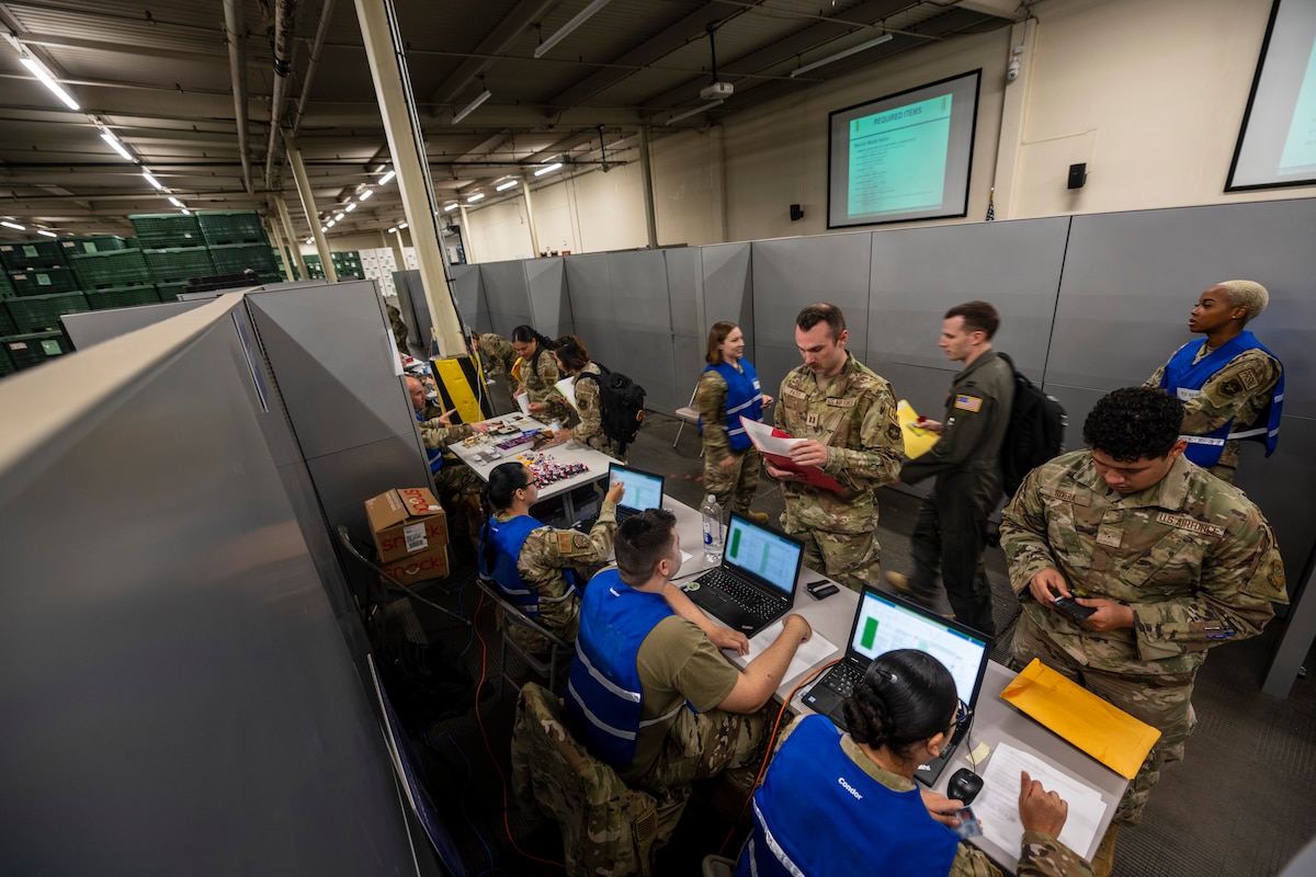 Airmen process through a personnel deployment function line