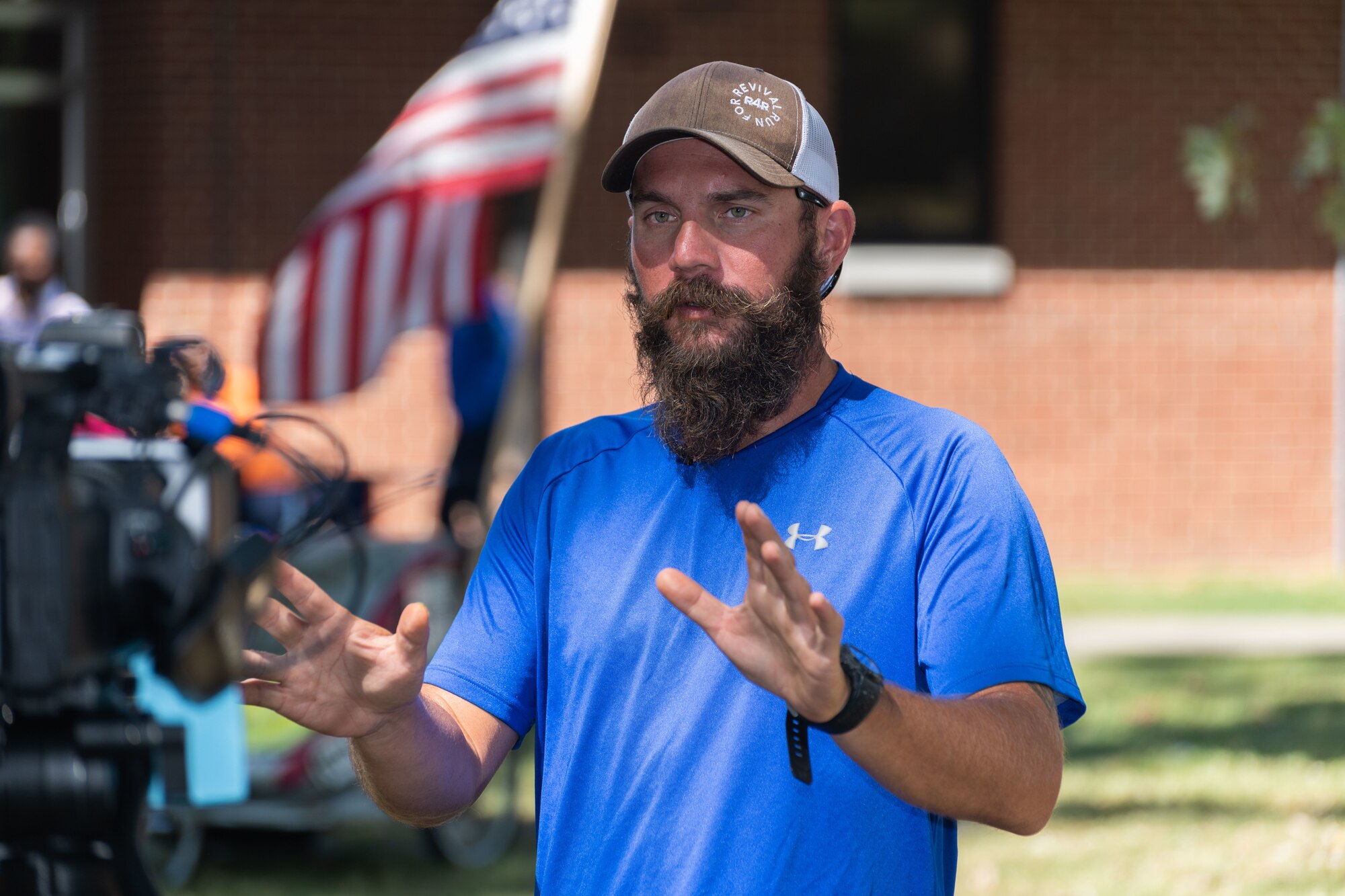 Noah Coughlan, founder of Run4Revival, takes time for an on-camera interview with the Arnold Air Force Base videographer during the Veterans Appreciation Picnic event Oct. 3, 2023, at the Arnold Lakeside Complex on Arnold AFB, Tenn. Run4Revival is a coast-to-coast solo run Coughlan undertook earlier this year to pay tribute to American soldiers and their families. He departed from Blaine, Wash., located near the Canadian border on May 29 to coincide with Memorial Day. He intends to conclude his 3,500-mile journey in the Miami-Fort Lauderdale, Fla., area on Nov. 11 to coincide with Veterans Day. Coughlan stopped by Arnold during his run to meet with base personnel. (U.S. Air Force photo by Keith Thornburgh)