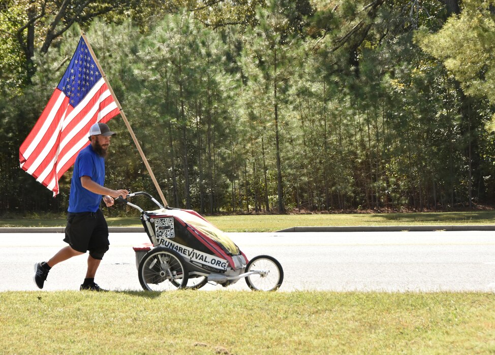 Noah Coughlan, founder of Run4Revival, approaches the Visitors’ Control Center at Arnold Air Force Base, Tenn., Oct. 3, 2023. Run4Revival is a coast-to-coast solo run Coughlan undertook earlier this year to pay tribute to American soldiers and their families. He departed from Blaine, Wash., located near the Canadian border on May 29 to coincide with Memorial Day. He intends to conclude his 3,500-mile journey in the Miami-Fort Lauderdale, Fla., area on Nov. 11 to coincide with Veterans Day. Coughlan stopped by Arnold during his run to meet with base personnel. (U.S. Air Force photo by Bradley Hicks)