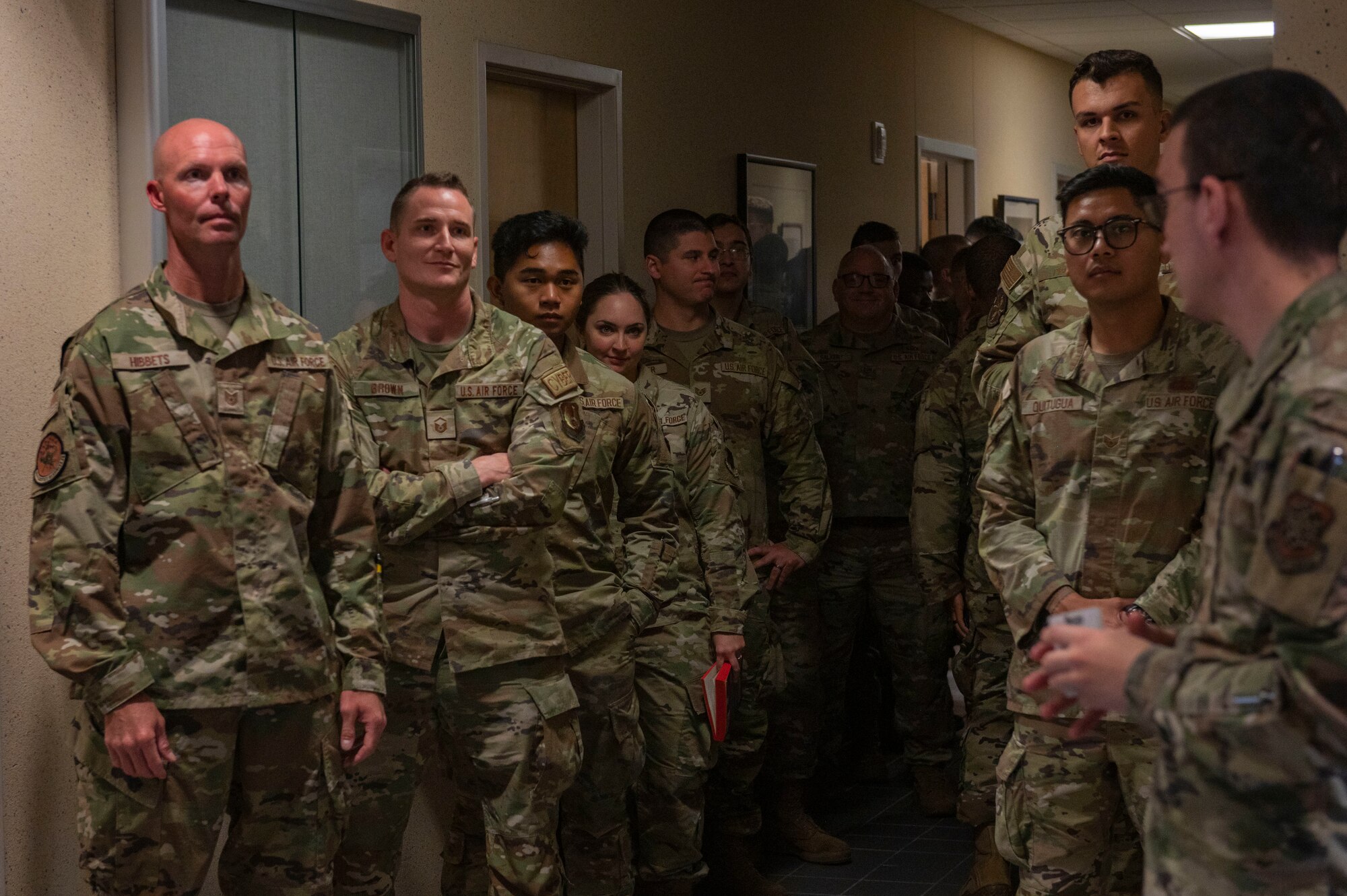 Airmen wait in a line.