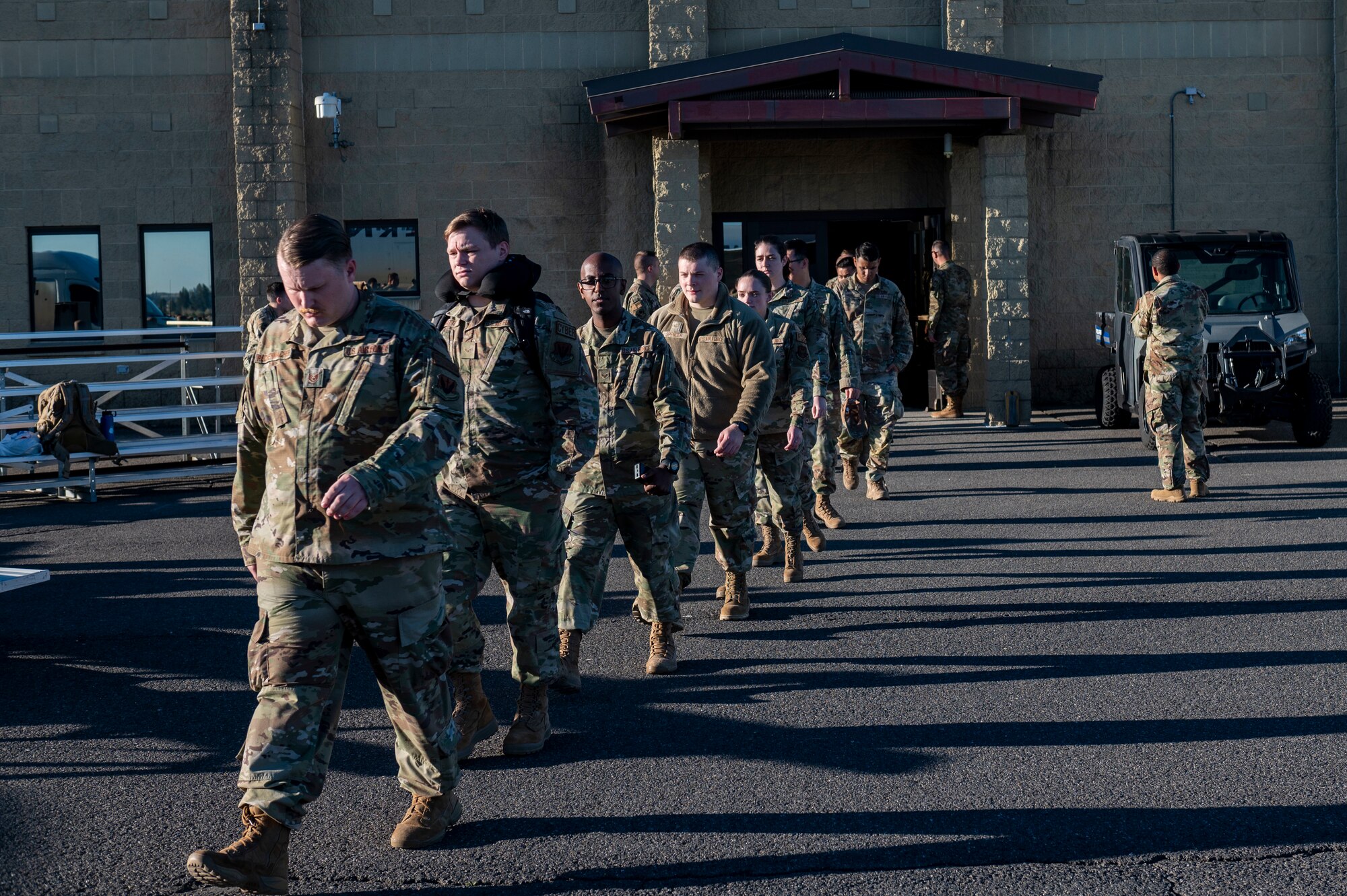 Airmen walk on the flightline.