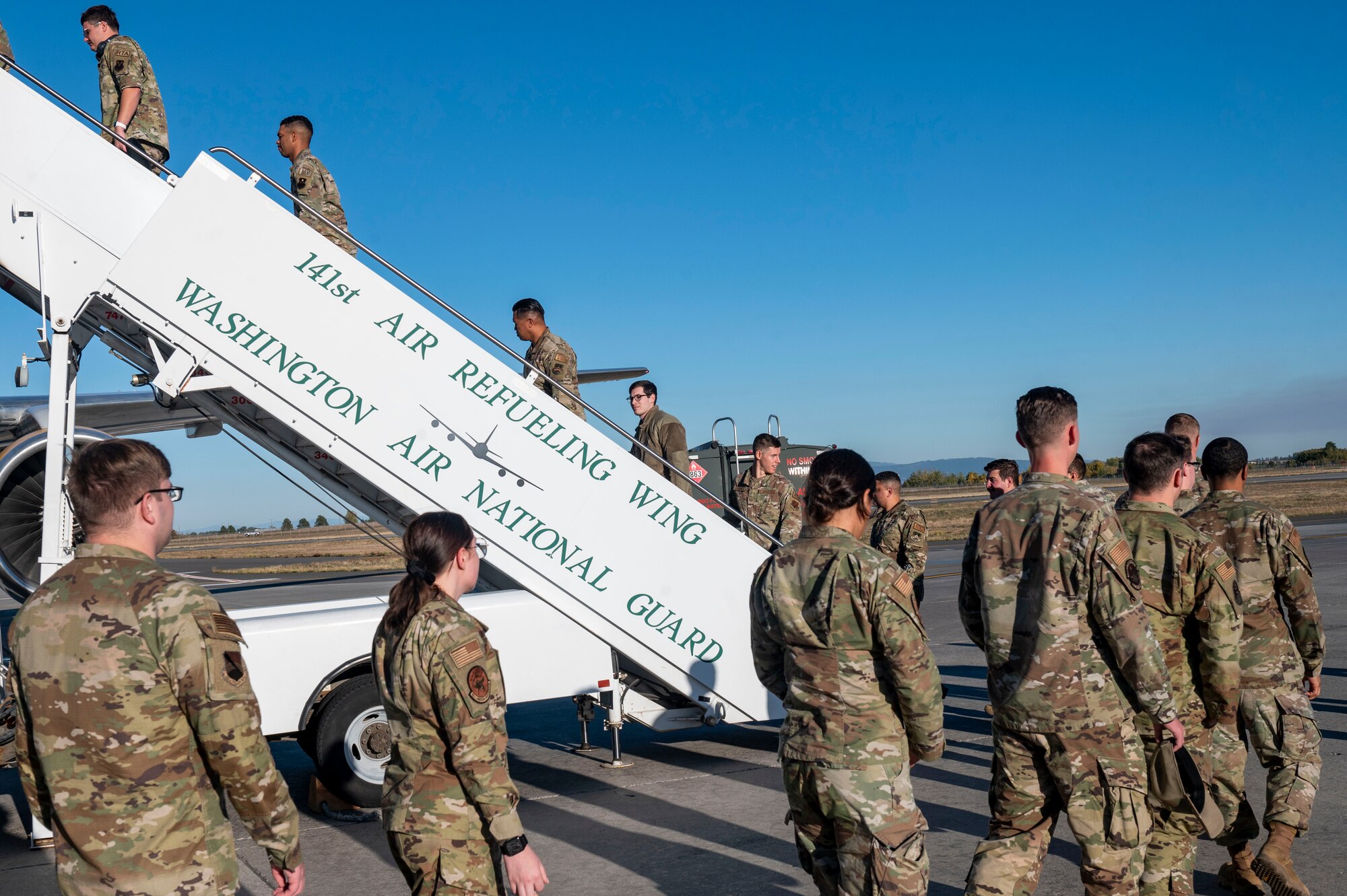 Airmen board a plane.