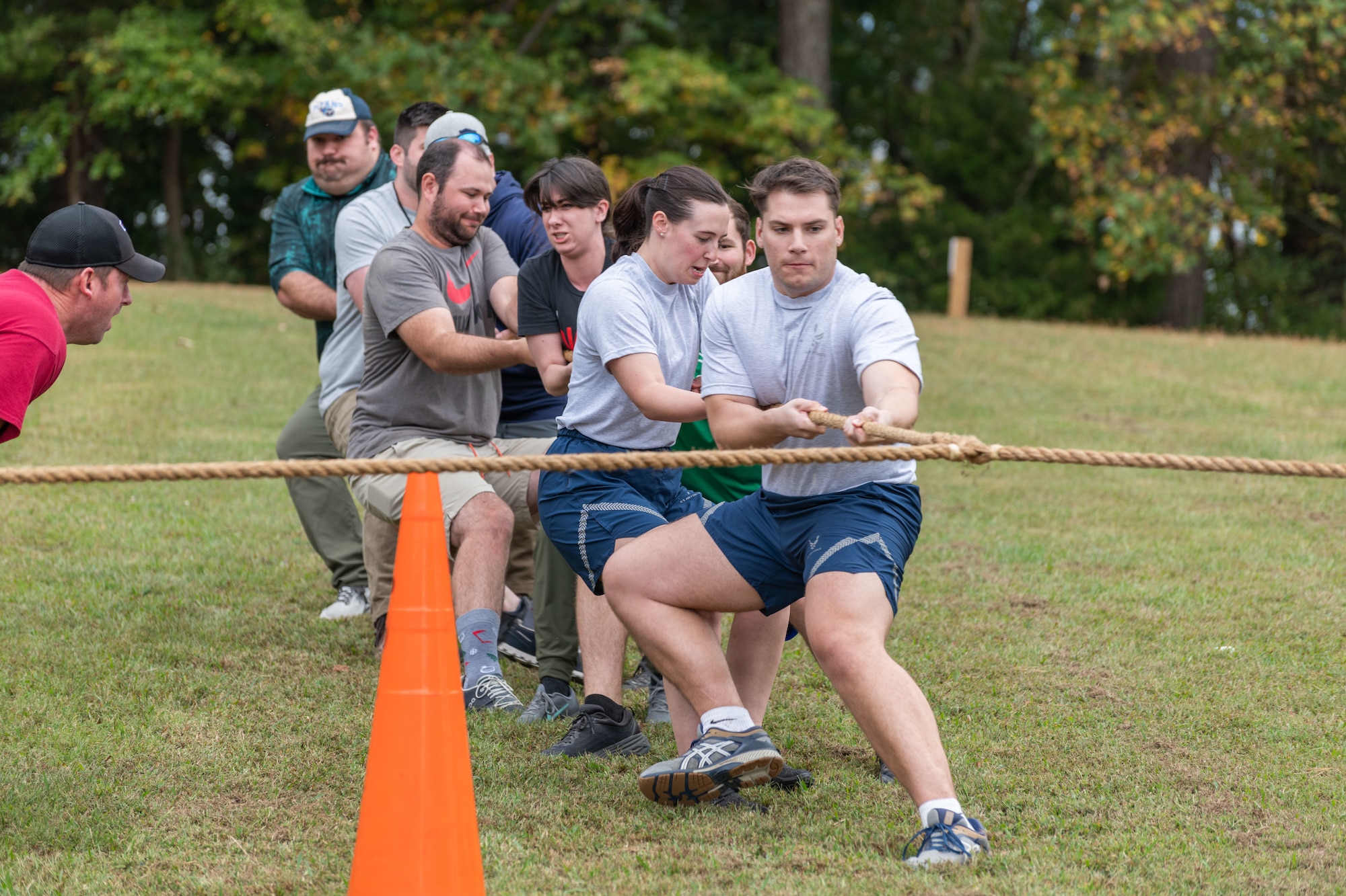 Team members from the Arnold Engineering Development Complex 804th Test Group hunker down during the tug of war portion of the Arnold Air Force Base Sports Day event, Oct. 5, 2023, at the Arnold Lakeside Complex at Arnold AFB, Tenn. Along with tug of war, events included running, pickleball, cornhole, volleyball, axe throwing, a dunk tank and disc golf. (U.S. Air Force photo by Keith Thornburgh)