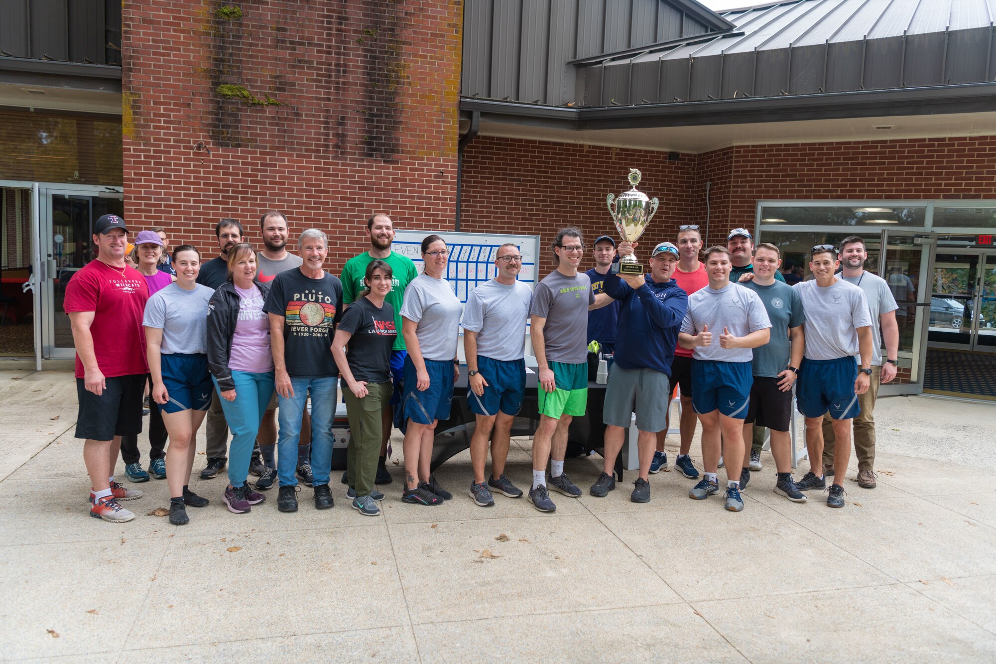 Members of the Arnold Engineering Development Complex 804th Test Group celebrate their Arnold Air Force Base Sports Day victory. Sports Day was held Oct. 5, 2023, and events included running, pickleball, cornhole, volleyball, axe throwing, tug of war, a dunk tank and disc golf. (U.S. Air Force photo by Keith Thornburgh)