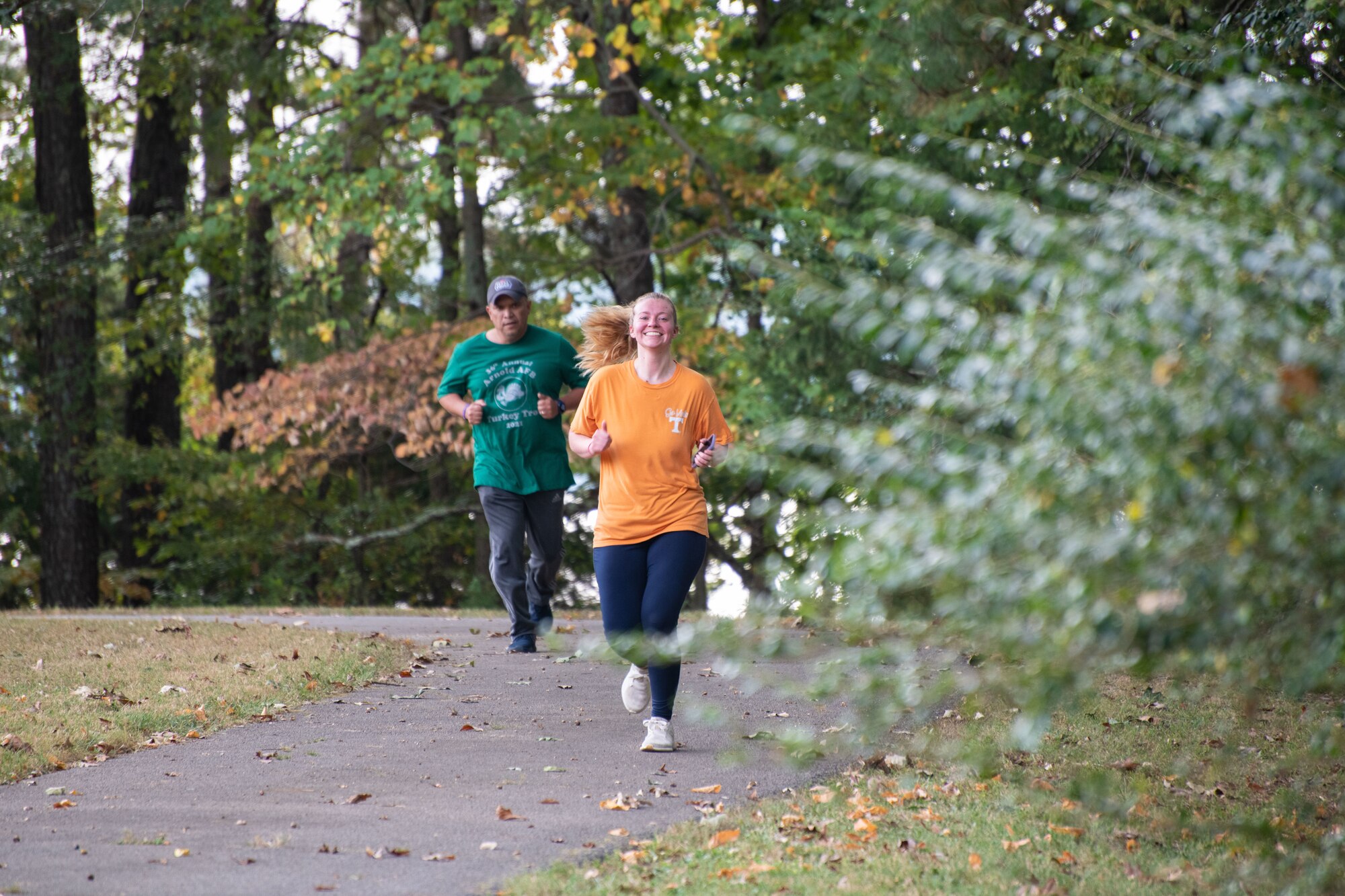 Base team members run for the finish line during the Arnold Air Force Base Sports Day event, Oct. 5, 2023, at the Arnold Lakeside Complex at Arnold AFB, Tenn. Along with running, events included volleyball, pickleball, cornhole, disc golf, axe throwing, tug of war and a dunk tank. (U.S. Air Force photo by Keith Thornburgh)