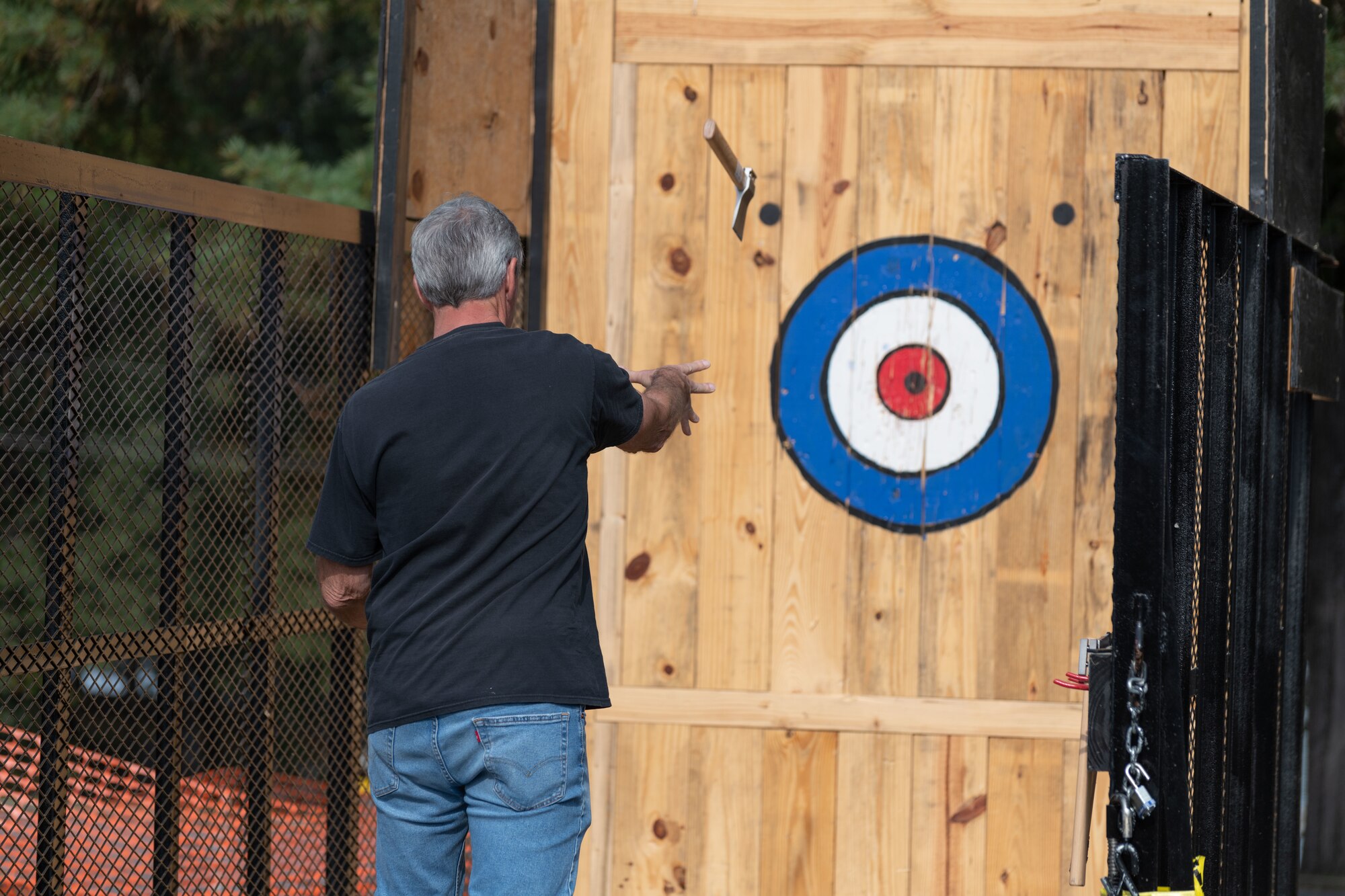 A base team member aims for the bullseye while participating in the axe throwing portion of the Arnold Air Force Base Sports Day event, Oct. 5, 2023, at the Arnold Lakeside Complex at Arnold AFB, Tenn. Along with axe throwing, events included volleyball, pickleball, cornhole, disc golf, running, tug of war and a dunk tank. (U.S. Air Force photo by Keith Thornburgh)