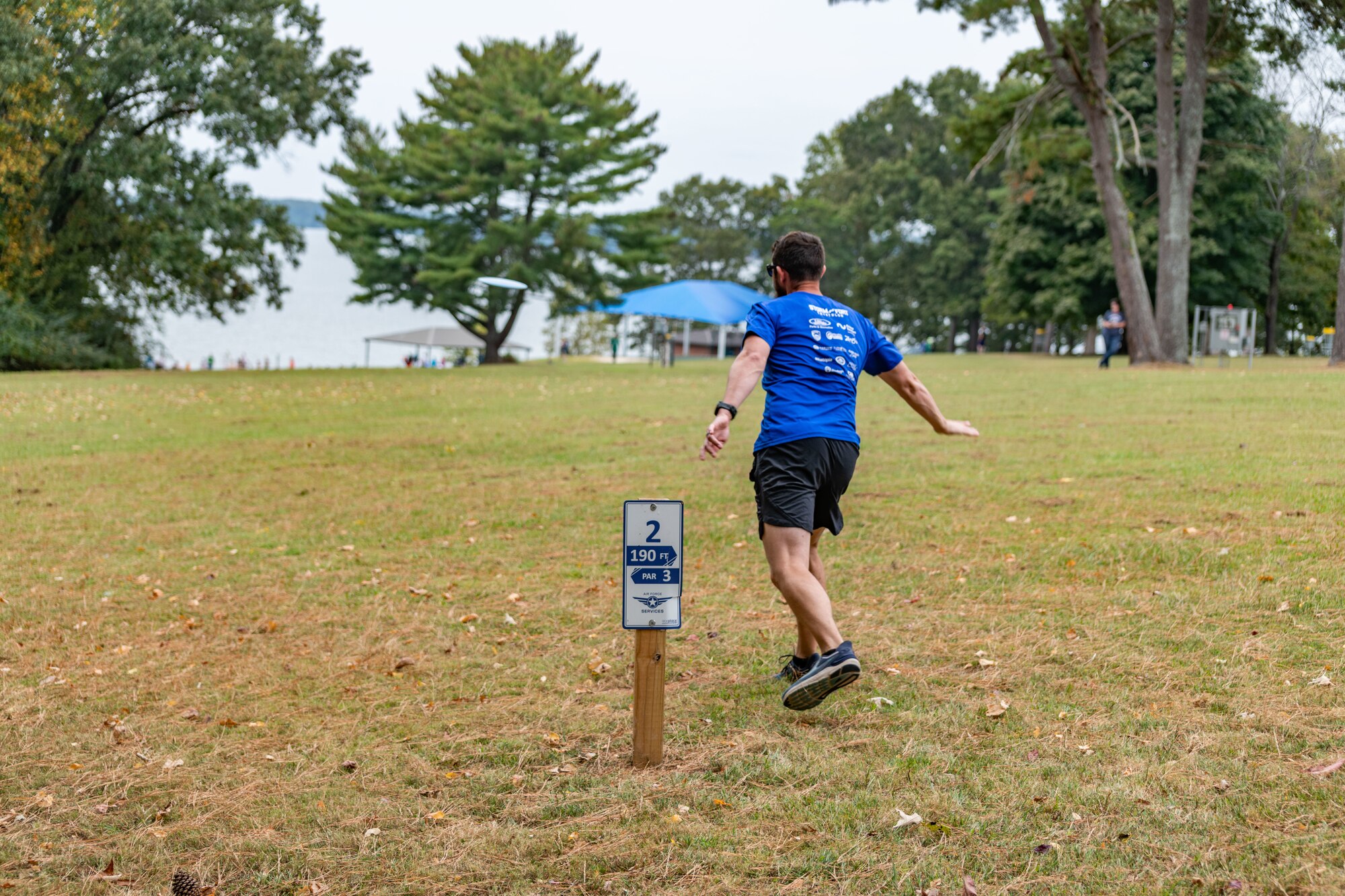 A base team member unleashes a drive while participating in the disc golf portion of the Arnold Air Force Base Sports Day event, Oct. 5, 2023, at the Arnold Lakeside Complex at Arnold AFB, Tenn. Along with disc golf, events included running, pickleball, cornhole, volleyball, axe throwing, tug of war and a dunk tank. (U.S. Air Force photo by Keith Thornburgh)