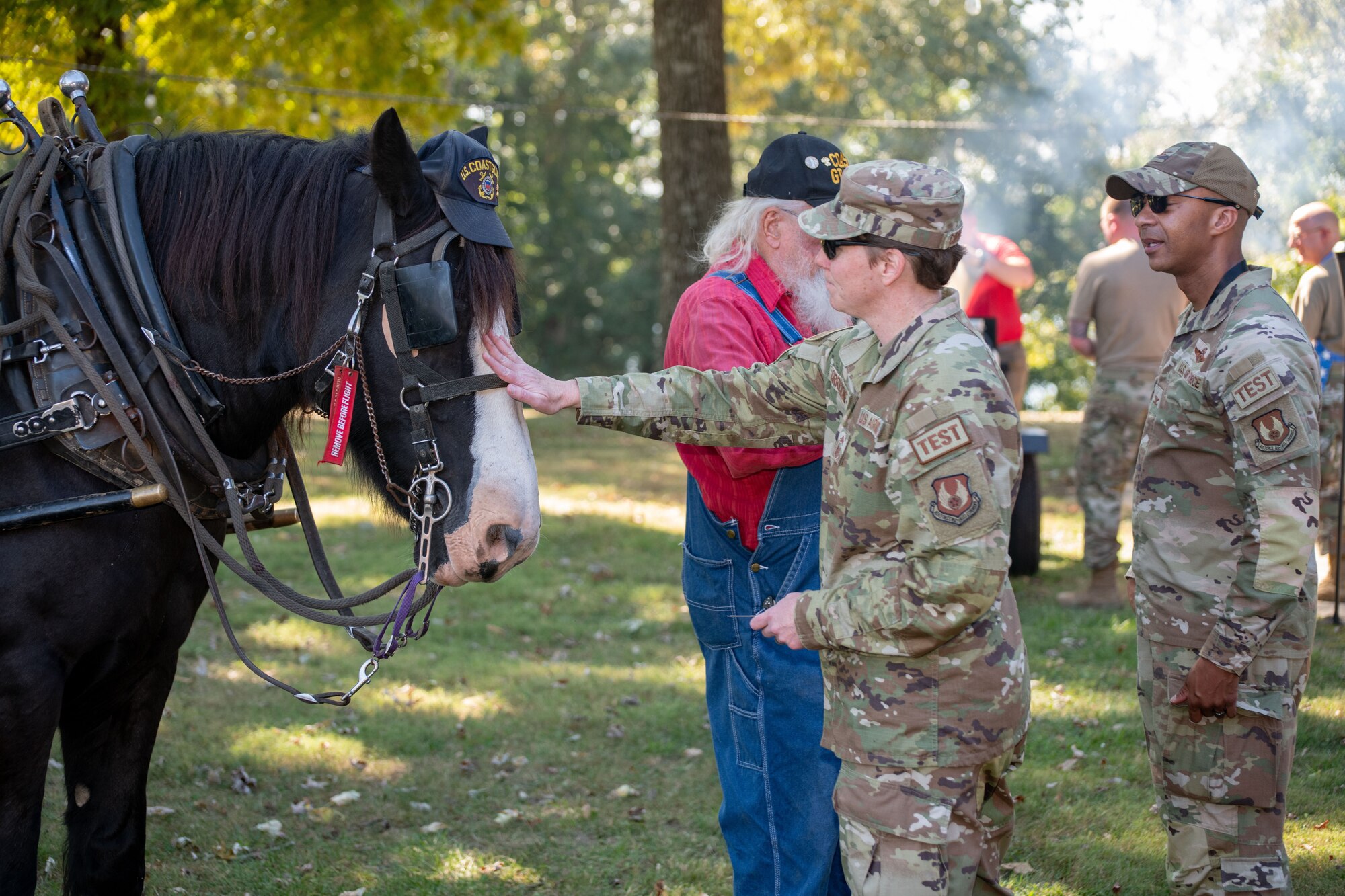 Chief Master Sgt. Jennifer Cirricione, senior enlisted leader of Arnold Engineering Development Complex, left, and Col. Randall Gordon, AEDC commander, spend some time with horse, “C. Moore.” Owner Woodye Bedford and his horse provided carriage rides for attendees at the Veterans Appreciation Picnic that took place at Arnold Lakeside Complex at Arnold Air Force Base, Tenn., Oct. 3, 2023. (U.S. Air Force photo by Keith Thornburgh)