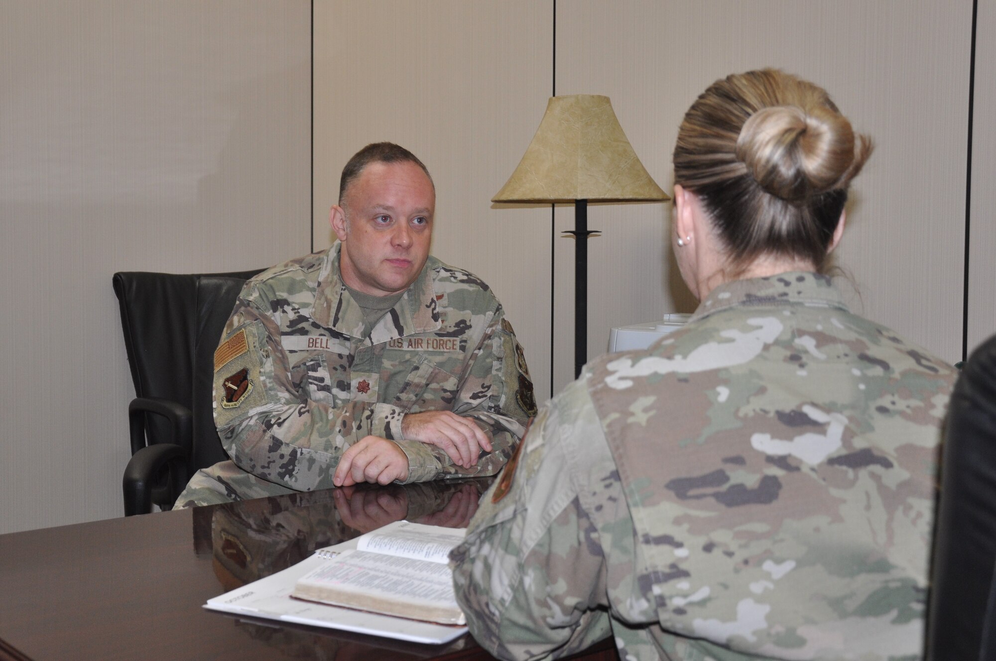 two people talk at a table