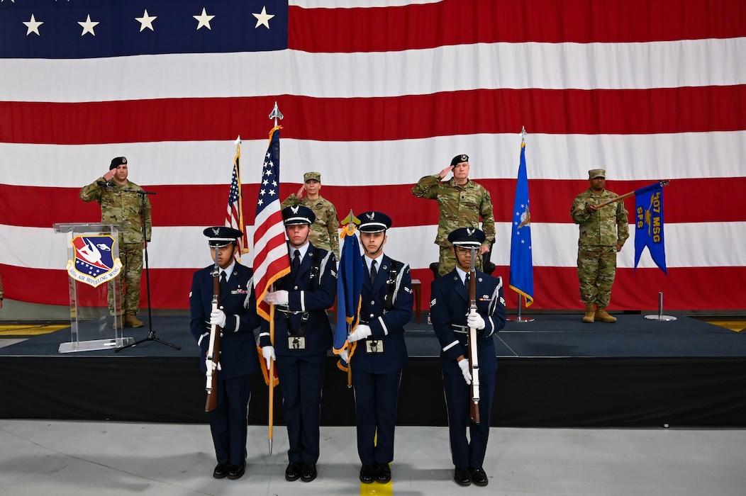 people presenting the American flag, while others salute