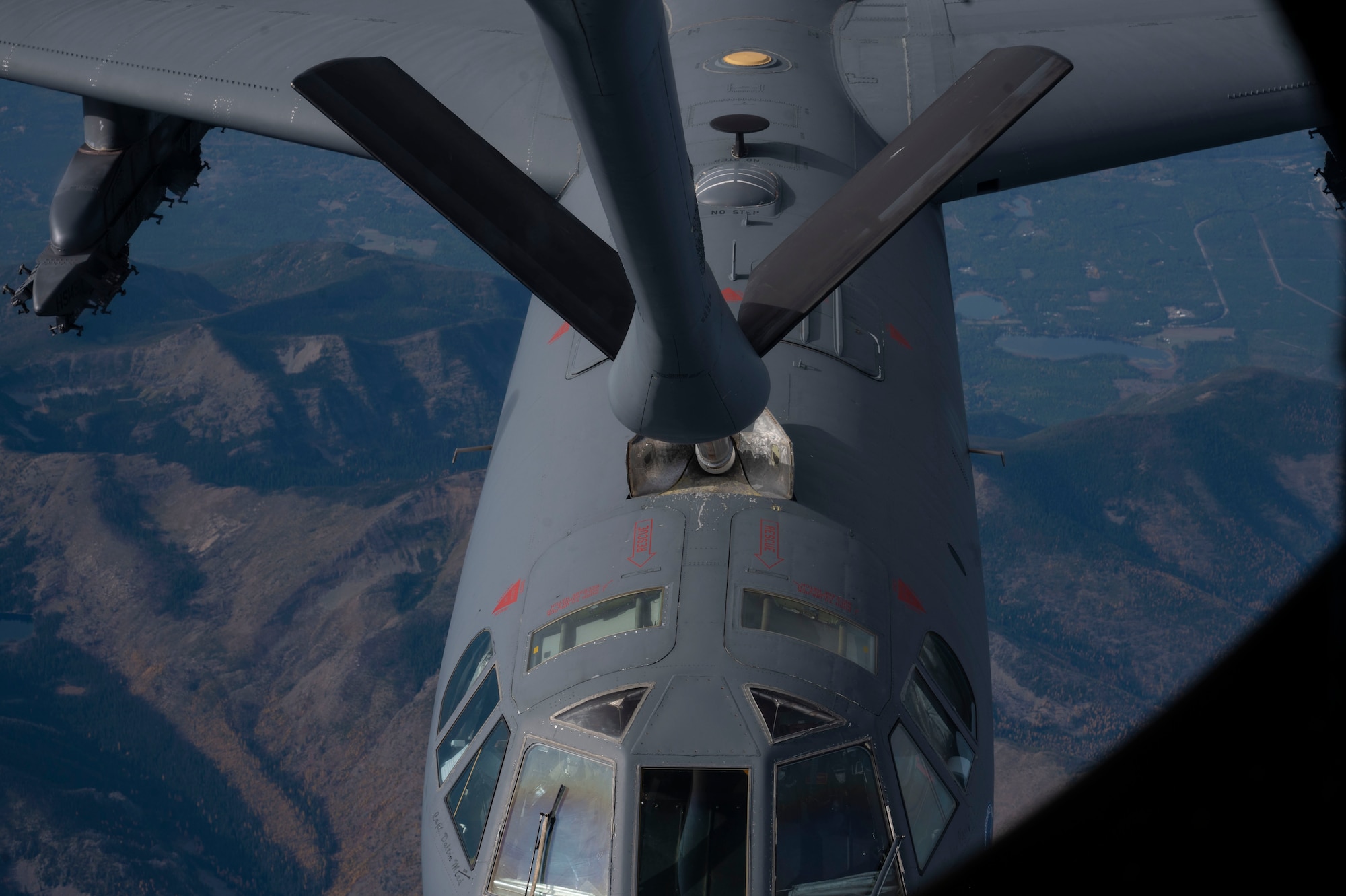 A B 52 Stratofortress receives aerial refueling from a KC 135 Stratotanker.