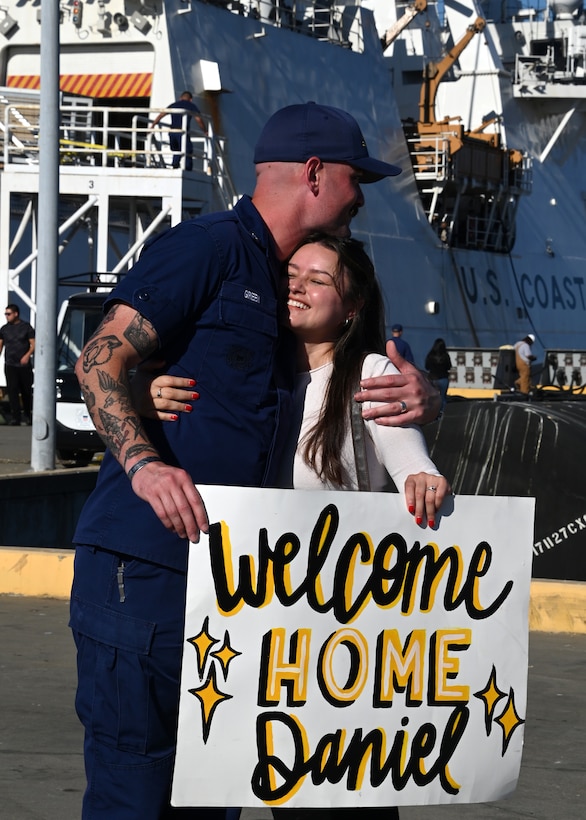 Petty Officer 3rd Class Daniel Green, a gunner's mate aboard the U.S. Coast Guard Cutter Munro (WSML 755), embraces his loved on the pier at Base Alameda, California, after the cutter returned home from a 118-day Western Pacific deployment, Oct. 18. 2023. Munro's crew conducted a 23,000-mile, multi-month Western Pacific patrol operating in support of the U.S. Navy's Seventh Fleet by conducting multiple engagements with partner nations promoting a free and open Indo-Pacific. U.S. Coast Guard photo by Chief Petty Officer Matthew S. Masaschi.