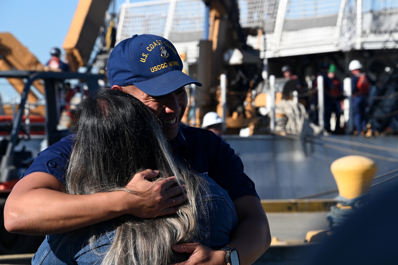 Chief Petty Officer London Venzon, a storekeeper aboard the U.S. Coast Guard Cutter Munro (WSML 755), embraces his loved one on the pier at Base Alameda, California, after Munro returned home from a 118-day Western Pacific deployment, Oct. 18. 2023. Munro's crew conducted a 23,000-mile, multi-month Western Pacific patrol operating in support of the U.S. Navy's Seventh Fleet by conducting multiple engagements with partner nations promoting a free and open Indo-Pacific. U.S. Coast Guard photo by Chief Petty Officer Matthew S. Masaschi.