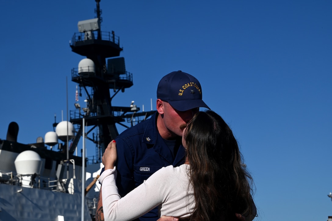 Petty Officer 3rd Class Daniel Green, a gunner's mate aboard the U.S. Coast Guard Cutter Munro (WSML 755), embraces his loved on the pier at Base Alameda, California, after the cutter returned home from a 118-day Western Pacific deployment, Oct. 18. 2023. Munro's crew conducted a 23,000-mile, multi-month Western Pacific patrol operating in support of the U.S. Navy's Seventh Fleet by conducting multiple engagements with partner nations promoting a free and open Indo-Pacific. U.S. Coast Guard photo by Chief Petty Officer Matthew S. Masaschi.