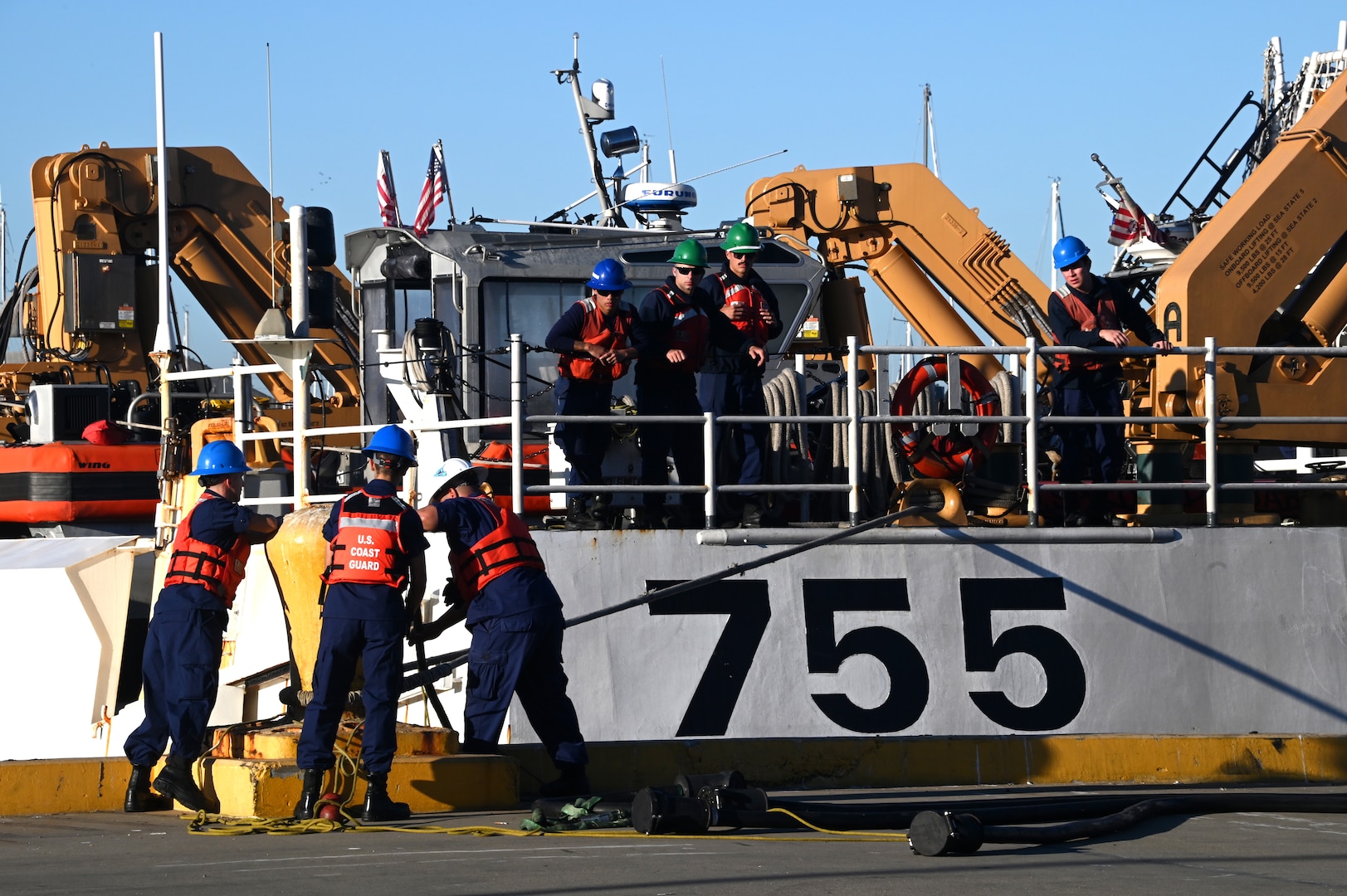 Line handlers secure lines from the U.S. Coast Guard Cutter Munro (WSML 755) to the pier on Base Alameda, California, after the cutter returned home from a 118-day Western Pacific deployment, Oct. 18. 2023. Munro's crew conducted a 23,000-mile, multi-month Western Pacific patrol operating in support of the U.S. Navy's Seventh Fleet by conducting multiple engagements with partner nations promoting a free and open Indo-Pacific. U.S. Coast Guard photo by Chief Petty Officer Matthew S. Masaschi.