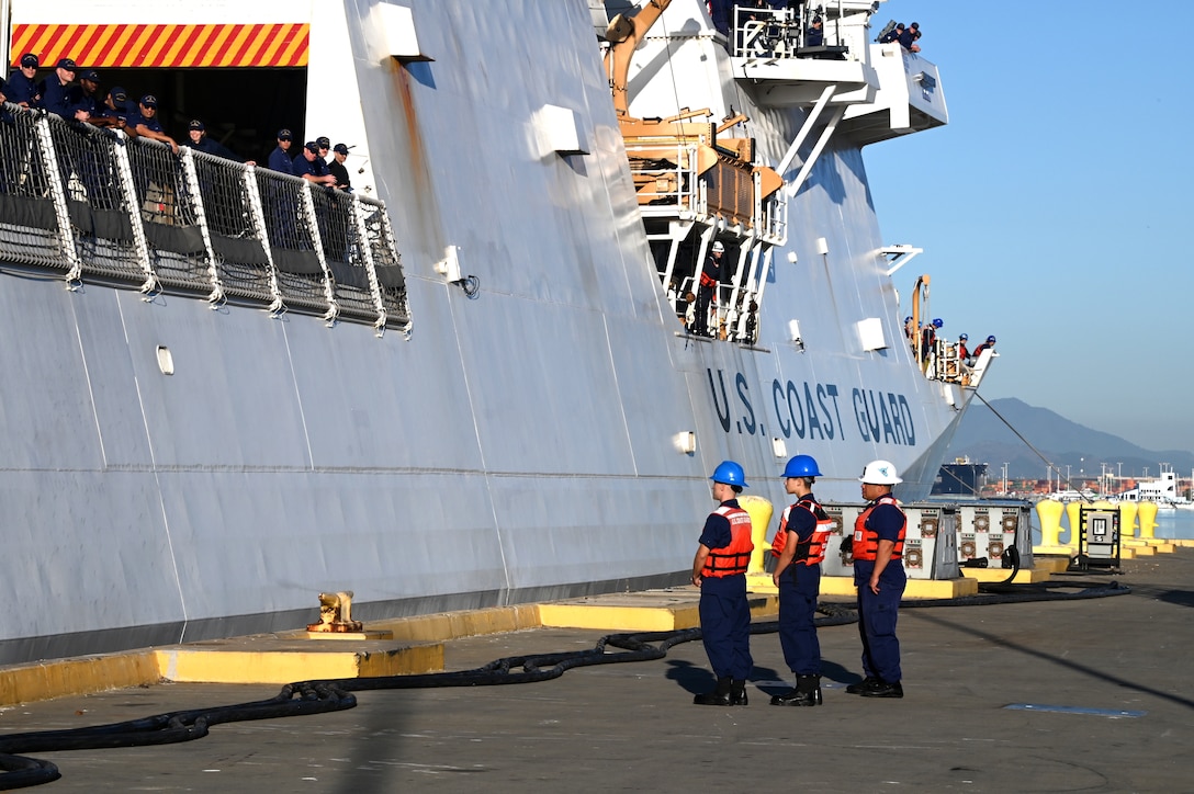 Line handlers await to secure the Coast Guard Cutter Munro (WSML 755) to the Base Alameda, California pier after the cutter returned home from a 118-day Western Pacific deployment, Oct. 18. 2023. Munro's crew conducted a 23,000-mile, multi-month Western Pacific patrol operating in support of the U.S. Navy's Seventh Fleet by conducting multiple engagements with partner nations promoting a free and open Indo-Pacific. U.S. Coast Guard photo by Chief Petty Officer Matthew S. Masaschi.