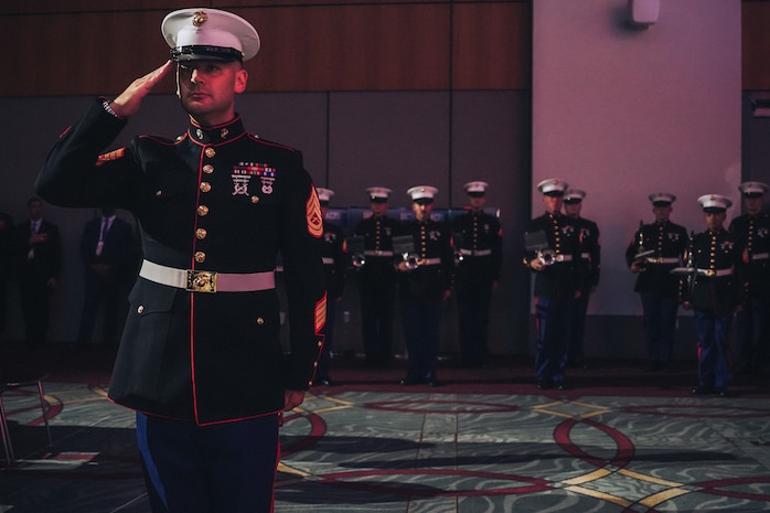 U.S. Marine Corps Gunnery Sgt. Ben Hallquist, enlisted conductor with Marine Band San Diego, renders a salute to honor colors during the 130th International Chiefs of Police Convention at the San Diego Convention Center Oct. 14, 2023. The Marine Band San Diego performed before the convention started, which consisted of law enforcement professionals gathering to advance their knowledge within the career field. (U.S. Marine Corps photo by Lance Cpl. Francisco Angel)