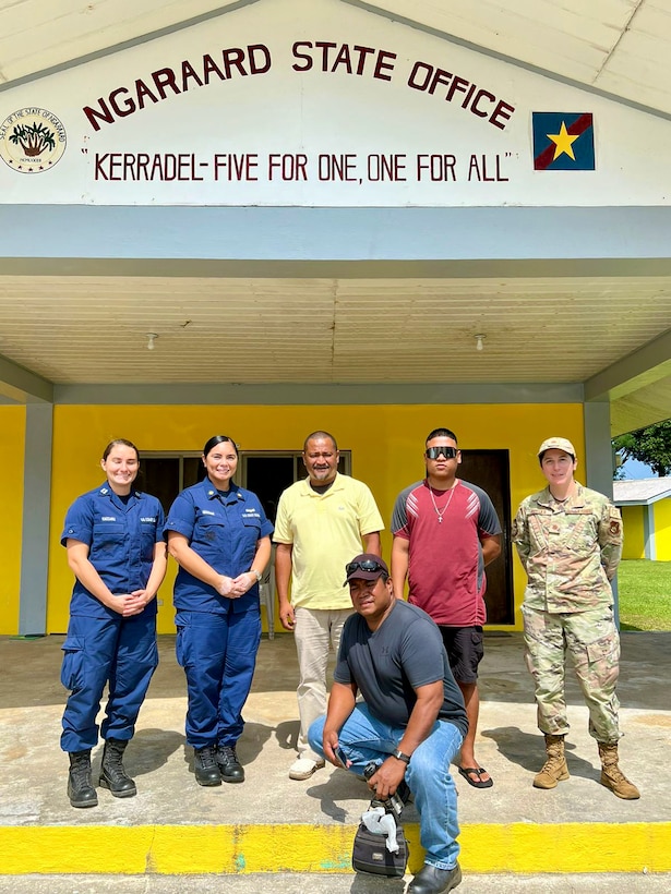 Lt. Anna Vaccaro and Lt. Cmdr. Christine Igisomar stand for a photo with Governor Sharp Sakuma, the Ngaraard State Officer, Maj. Kittka, and Mr. Olkerill (kneeling) during a visit to Ngaraard in Palau in October 2023. Following the signing of an expanded bilateral law enforcement agreement in August, during the Joint Heads of Pacific Security conference, representatives of the U.S. Coast Guard and the Republic of Palau embarked on a series of meetings and initiatives to advance maritime partnership and promote regional stability. (U.S. Coast Guard photo)