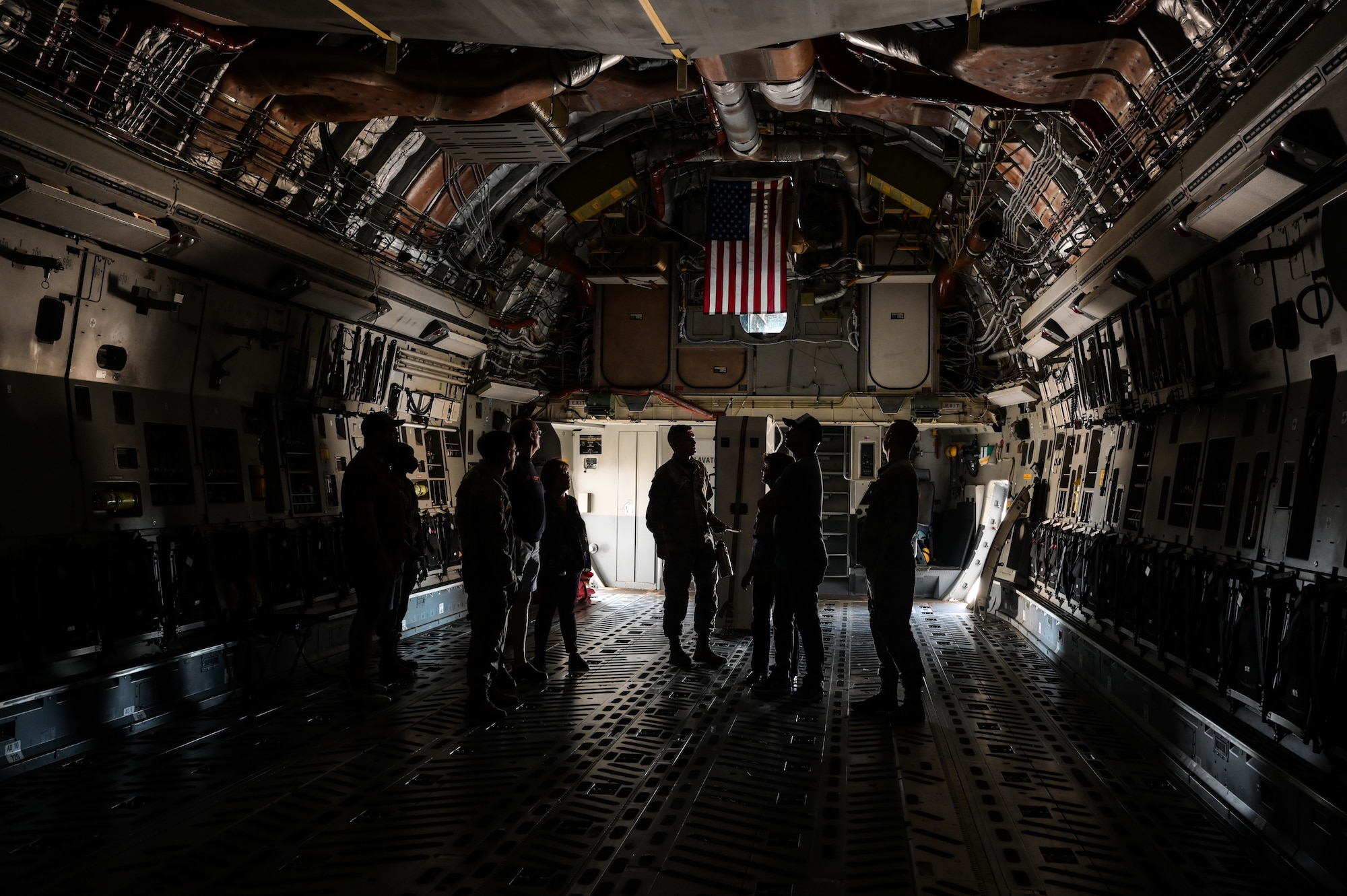 Members assigned to the 647th Logistics Readiness Squadron stand in the fuselage of a C-17 Globemaster III during a maintenance immersion tour at Joint Base Pearl Harbor-Hickam, Hawaii, Oct. 18, 2023. LRS personnel were briefed on the cargo aircraft’s capabilities and familiarized with their team’s direct impact on the 15th Wing’s operational readiness. (U.S. Air Force photo by Staff Sgt. Alan Ricker)
