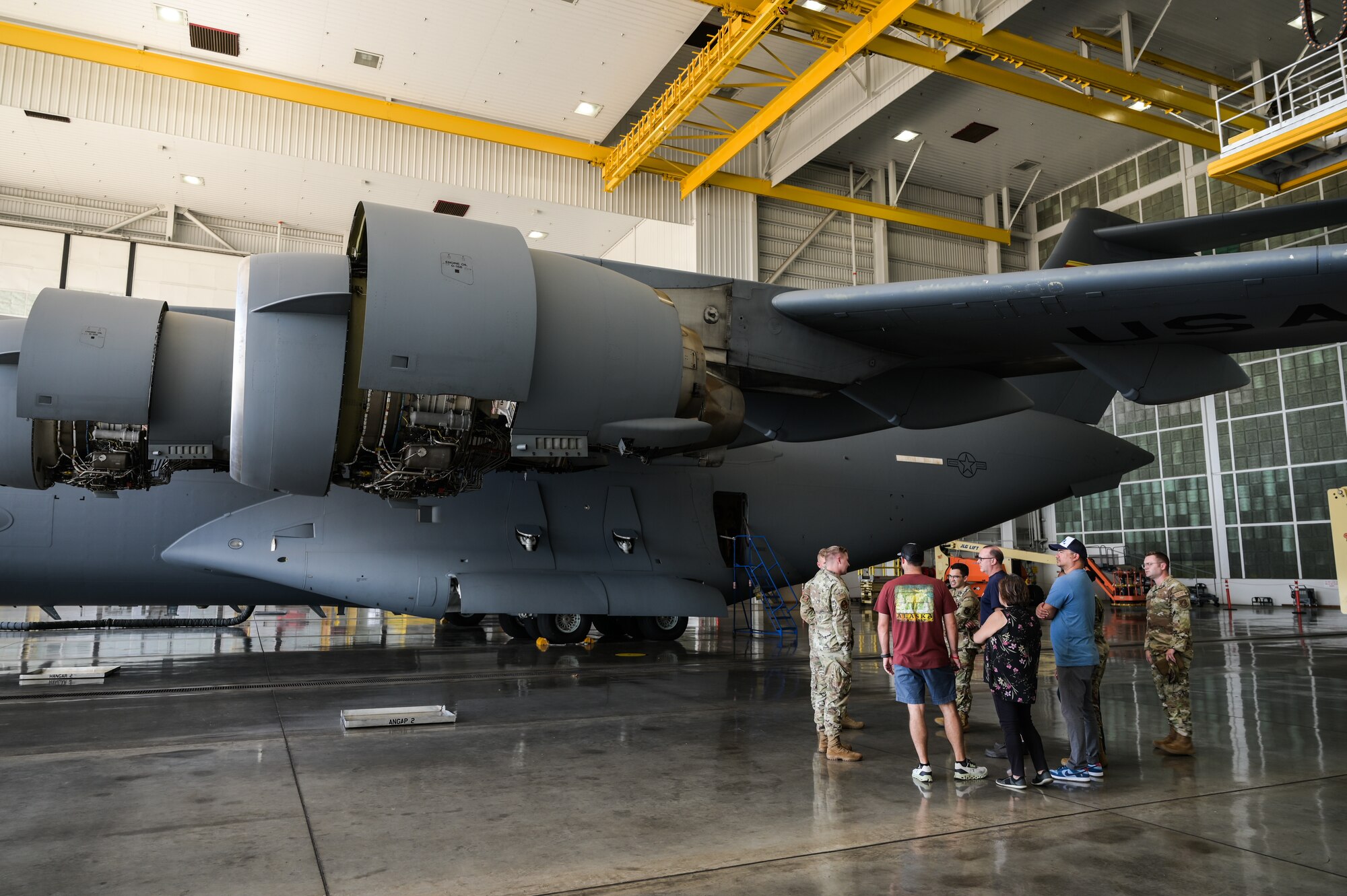 Members assigned to the 647th Logistics Readiness Squadron observe a C-17 Globemaster III home station check during a maintenance immersion tour at Joint Base Pearl Harbor-Hickam, Hawaii, Oct. 18, 2023. Immersion tours provide personnel an opportunity to see how their jobs can directly have an influence on mission readiness. (U.S. Air Force photo by Staff Sgt. Alan Ricker)