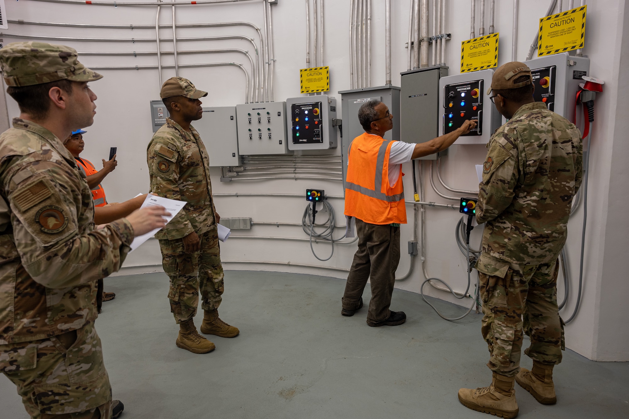 Photo of a contractor showing leadership how to operate a control panel