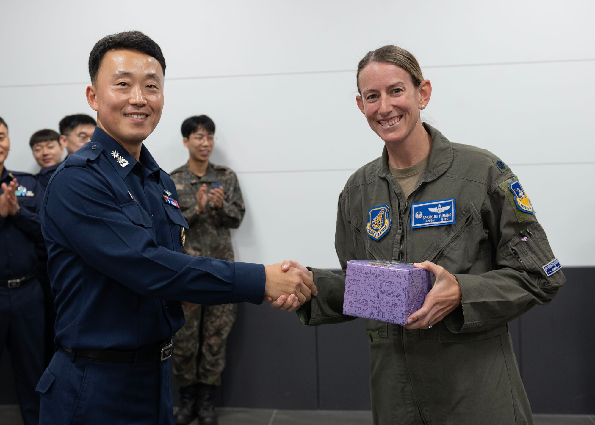Republic of Korea Air Force Lt. Col. Choi Young Dong, Republic of Korea Air Space and Aviation Education commander, and U.S. Air Force Lt. Col. Chandra Fleming, 51st Operations Support Squadron commander, come together to exchange techniques of managing aircraft movement dynamically through virtual simulations at the ROKAF Education and Training Command, Jinju, ROK, Oct. 12-13, 2023. The U.S.-ROK alliance has maintained peace and stability in Northeast Asia for over 70 years and led to the unapparelled economic growth and democratization of the ROK. (U.S. Air Force photo by Staff Sgt. Aubree Owens)