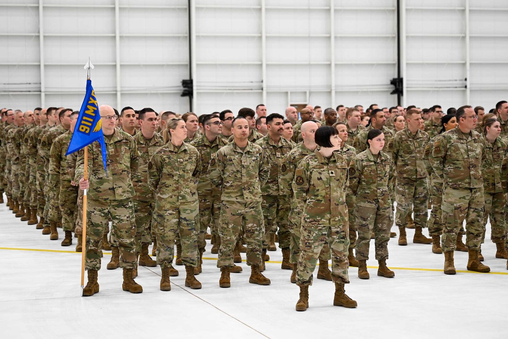 Airmen stand in formation.