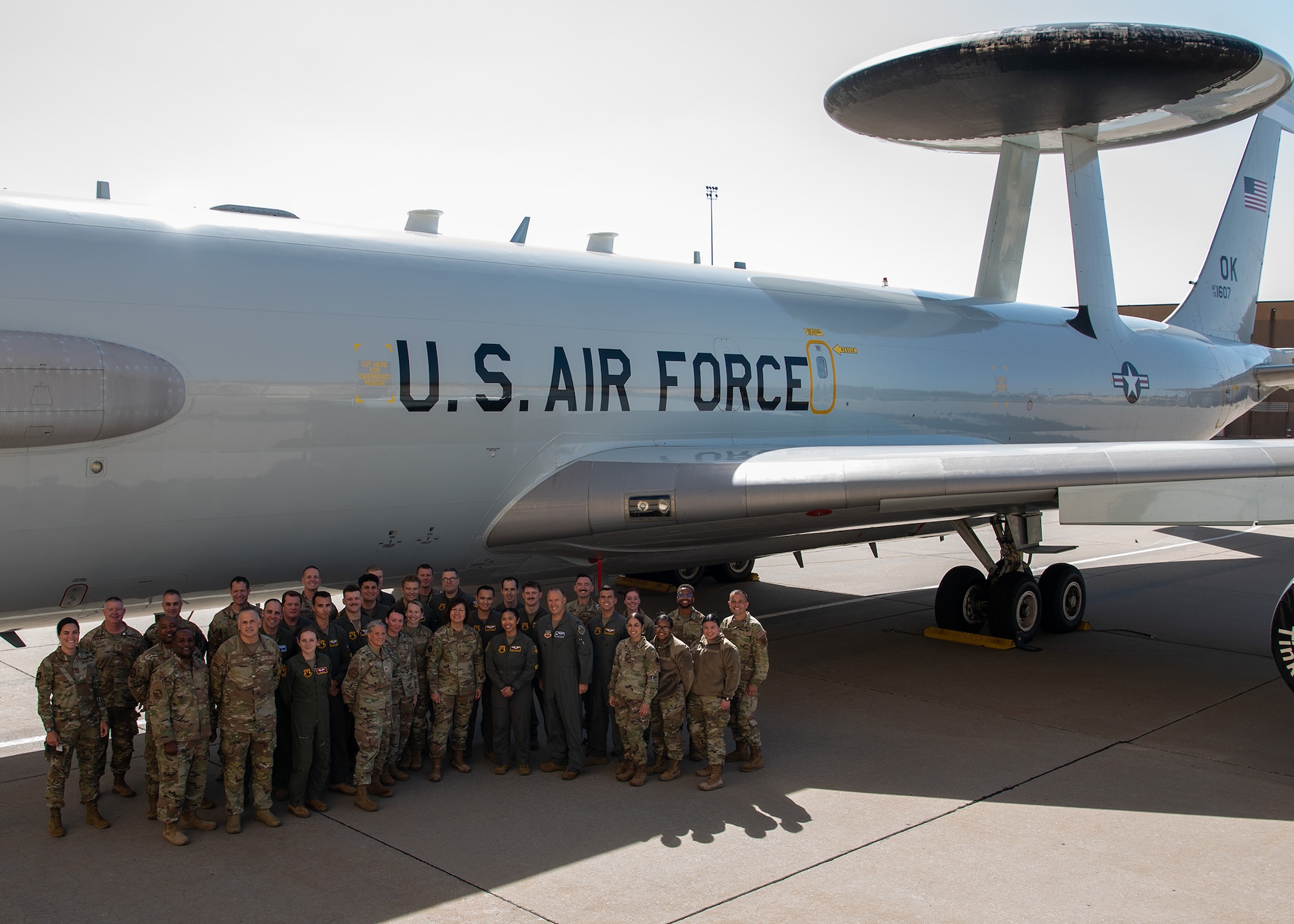 group photo in front of airplane
