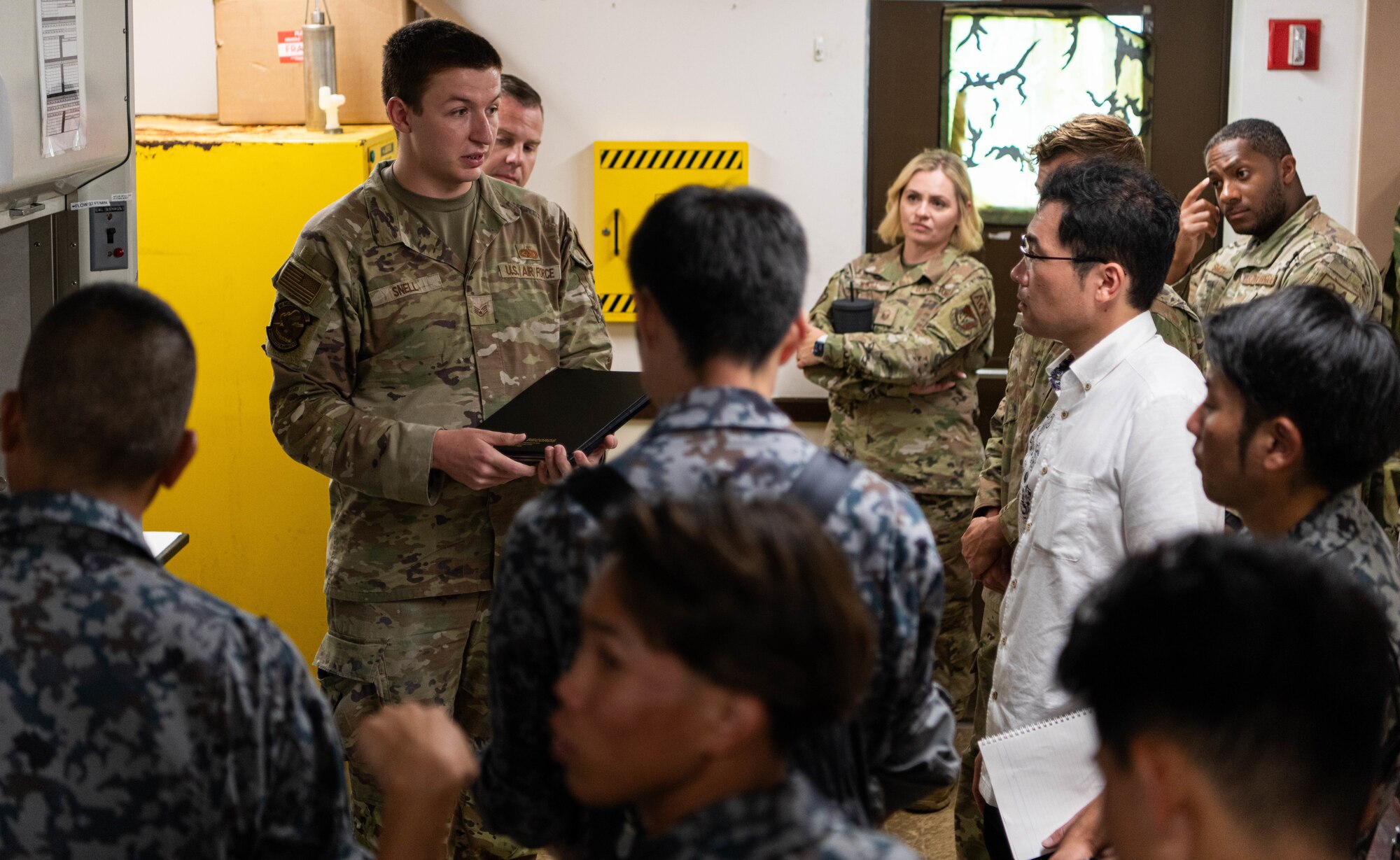 A group talk in a fuel research facility.