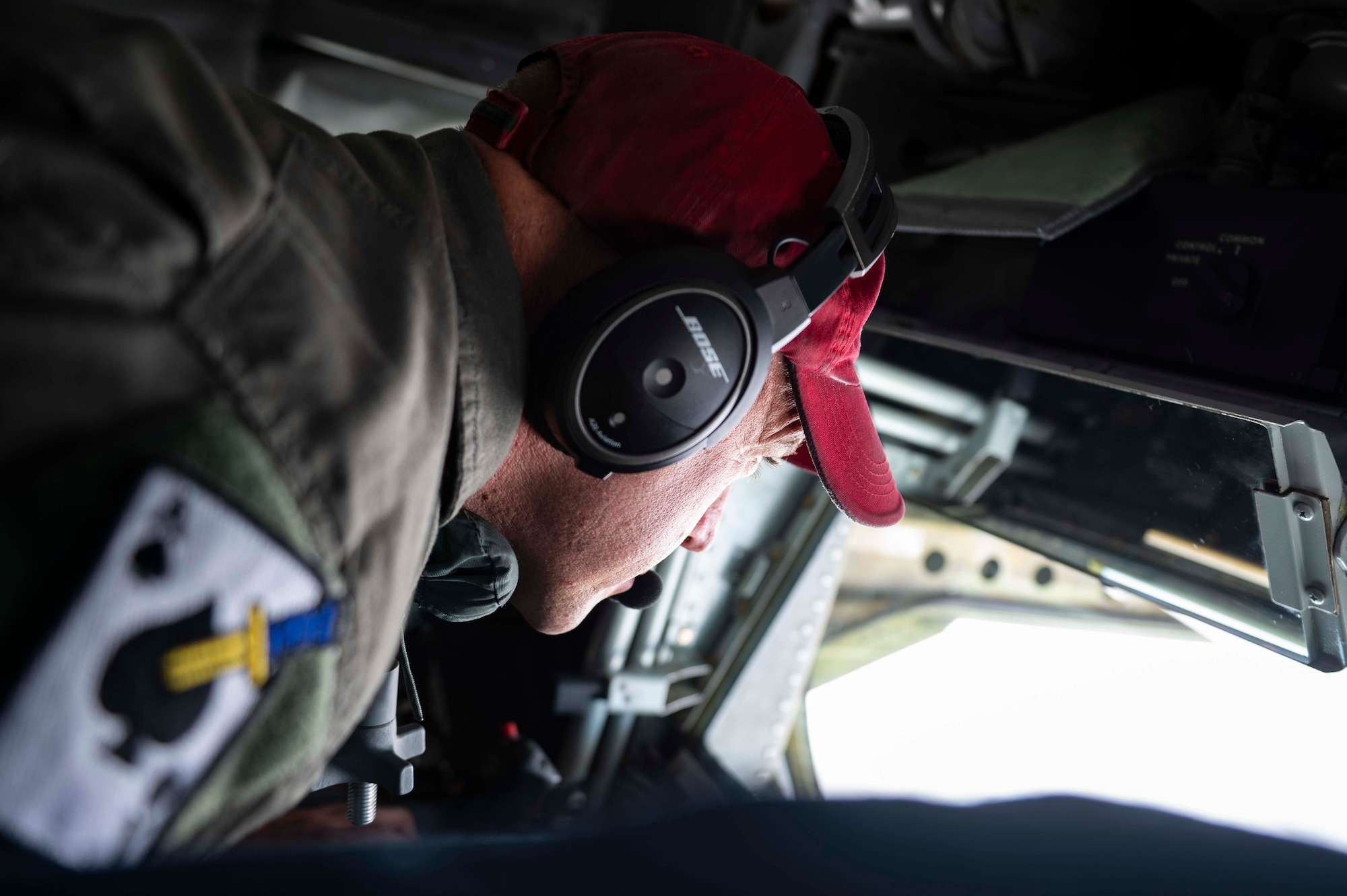 In-flight refueling specialist looks out the boom pod