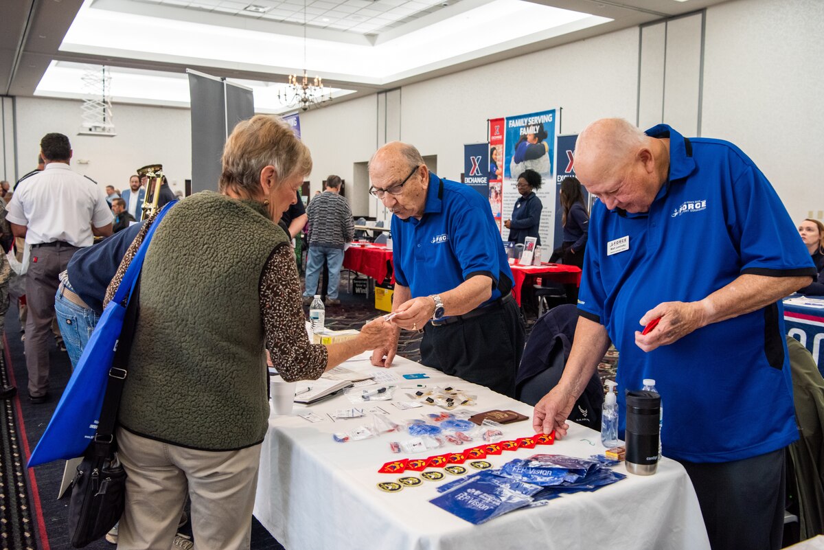 Attendees receive information from Retiree Affairs Office booth.