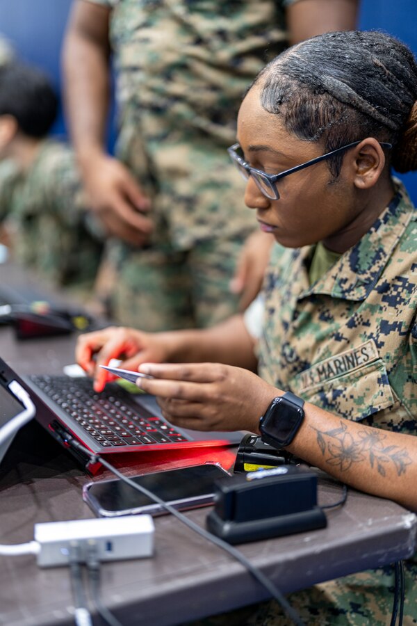 U.S. Marine Corps Lance Cpl. Diamond Berry, an administrative specialist with Headquarters and Headquarters Squadron, Marine Corps Air Station (MCAS) Iwakuni, enters information into a database during an Emergency Evacuation Program (EEP) exercise at MCAS Iwakuni, Japan, Oct. 5, 2023. The annual EEP exercise is designed to rehearse and refine evacuation procedures in the event of a real-world emergency or natural disaster. (U.S. Marine Corps photo by Sgt. Mitchell Austin)