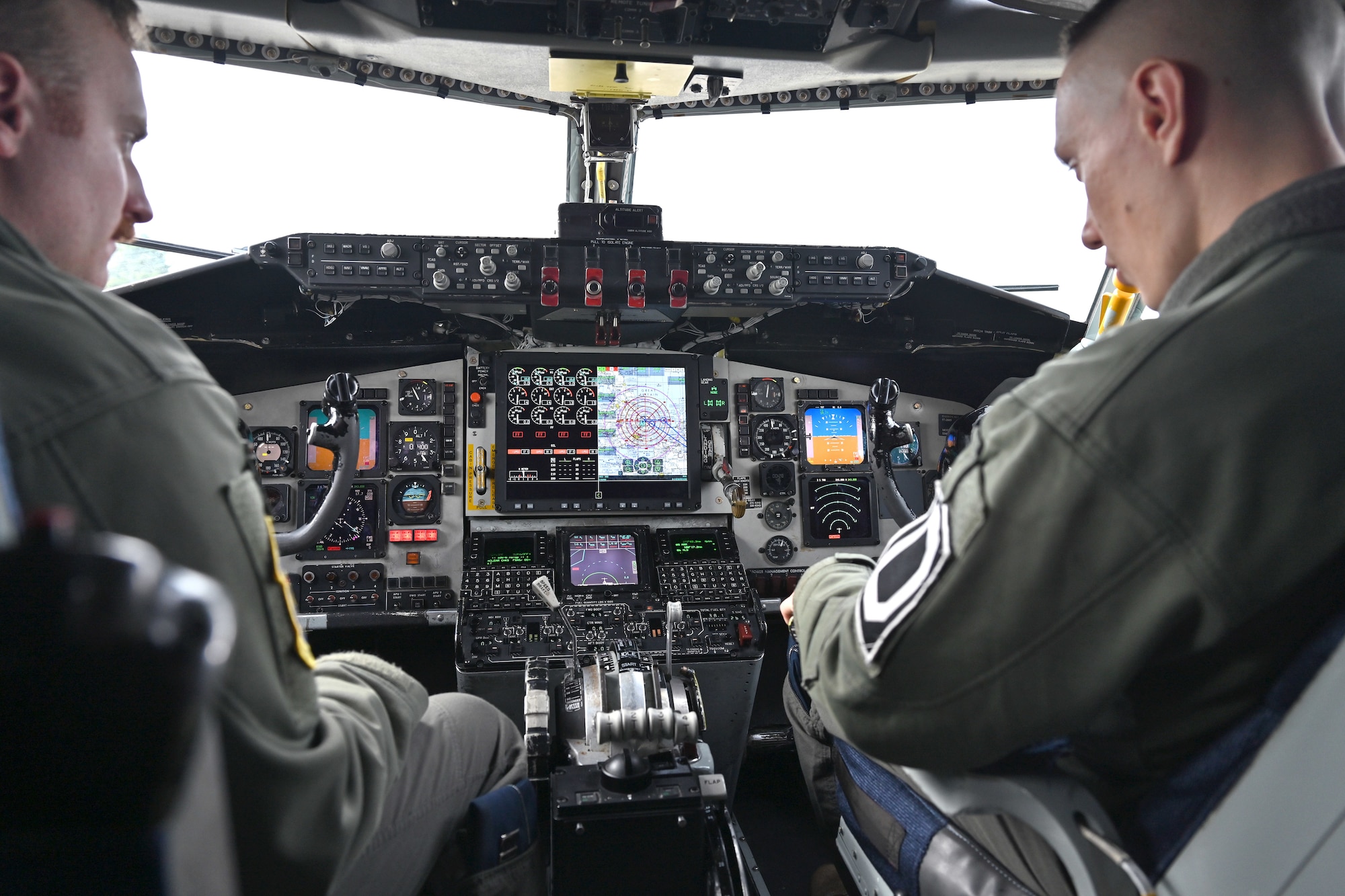 U.S. Air Force Capt. Jarod Suhr, left, 100th Operations Support Squadron pilot and wing tactics officer, clarifies points of the Real-time Information in the Cockpit system to Capt. Anthony Vecchio, 100th OSS pilot and wing tactics officer, on a KC-135 Stratotanker at Royal Air Force Mildenhall, England, Oct. 18, 2023. The newly installed communications system gives aircrew the ability to access vital information including threats, target data and locations of friendly forces, providing much more accurate and instant information. (U.S. Air Force photo by Karen Abeyasekere)