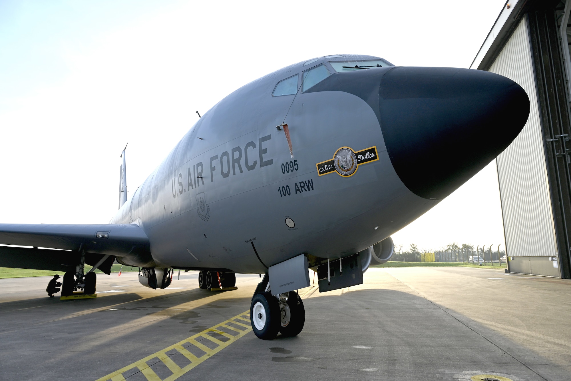 The latest of the 100th Air Refueling Wing’s heritage nose art, “Silver Dollar” is shown off after its unveiling during the nose art dedication ceremony at Royal Air Force Mildenhall, England, Oct. 10, 2023. The nose art, based on one from the 100th Bomb Group at Thorpe Abbotts, Norfolk, England, during World War II. U.S. Air Force Staff Sgt. Tyler Goldsborough, formerly 100th Aircraft Maintenance Squadron, now based at Tinker Air Force Base, Okla., designed the updated nose art – the first of RAF Mildenhall’s tanker fleet to sport double-sided nose art based on a Silver Dollar coin – now showcased on the side of a KC-135 Stratotanker. (U.S. Air Force photo by Karen Abeyasekere)
