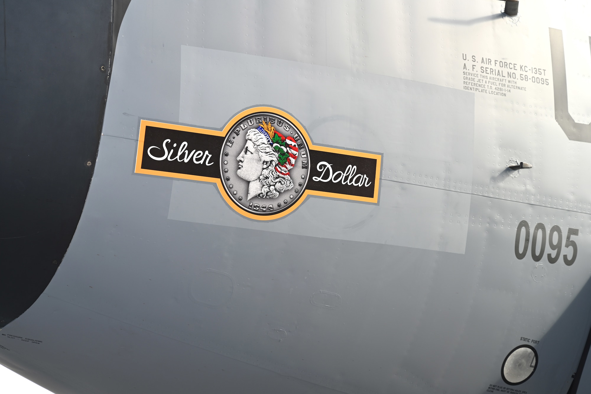 The latest of the 100th Air Refueling Wing’s heritage nose art, “Silver Dollar,” is shown off after its unveiling during the nose art dedication ceremony at Royal Air Force Mildenhall, England, Oct. 10, 2023. The nose art is based on one from the 100th Bomb Group at Thorpe Abbotts, Norfolk, England, during World War II. U.S. Air Force Staff Sgt. Tyler Goldsborough, formerly 100th Aircraft Maintenance Squadron, now stationed at Tinker Air Force Base, Okla., designed the nose art – the first of RAF Mildenhall’s tanker fleet to sport double-sided nose art based on a Silver Dollar coin – now showcased on the side of a KC-135 Stratotanker. (U.S. Air Force photo by Karen Abeyasekere)