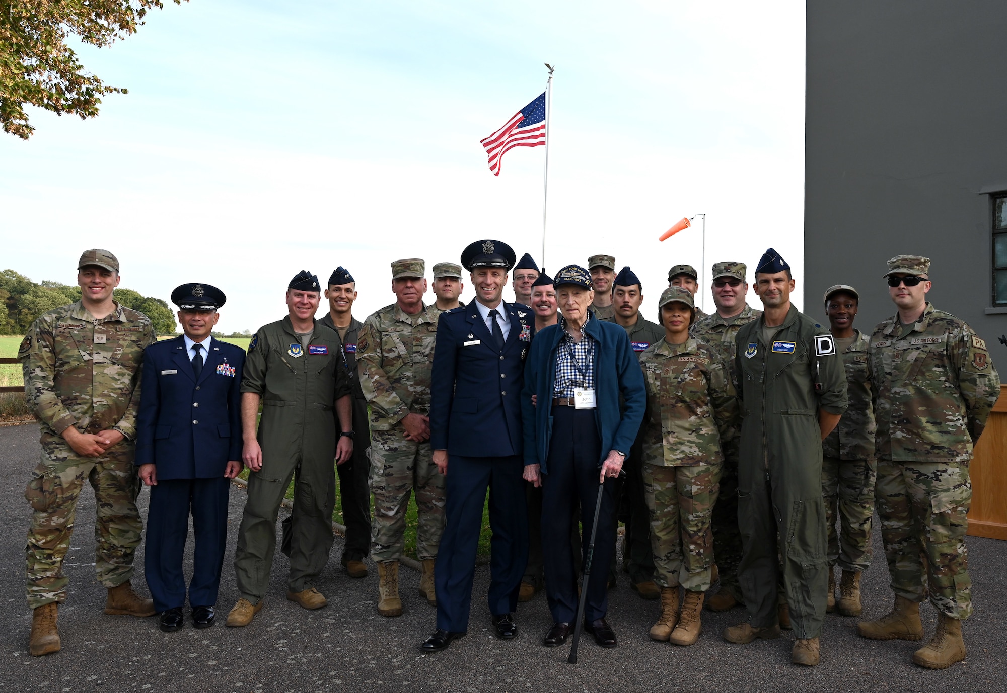 U.S. Air Force senior leaders and Airmen from the 100th Air Refueling Wing, Royal Air Force Mildenhall, are all smiles as they proudly pose for a photo with legendary World War II veteran and 100th Bomb Group B-17 pilot, retired-Maj. John “Lucky” Luckadoo, after a ceremony honoring the 80th anniversary of “Black Week” at the 100th BG Memorial Museum, Thorpe Abbotts, Norfolk, England, Oct. 10, 2023. Lucky flew 25 combat missions out of Thorpe Abbotts during World War II – the average being eight to 12 – and achieved his dream of returning to his former base in England to once again visit the control tower, buildings and original airfield, museum volunteers, Airmen from the 100th ARW and family members of other 100th BG veterans (U.S. Air Force photo by Karen Abeyasekere)