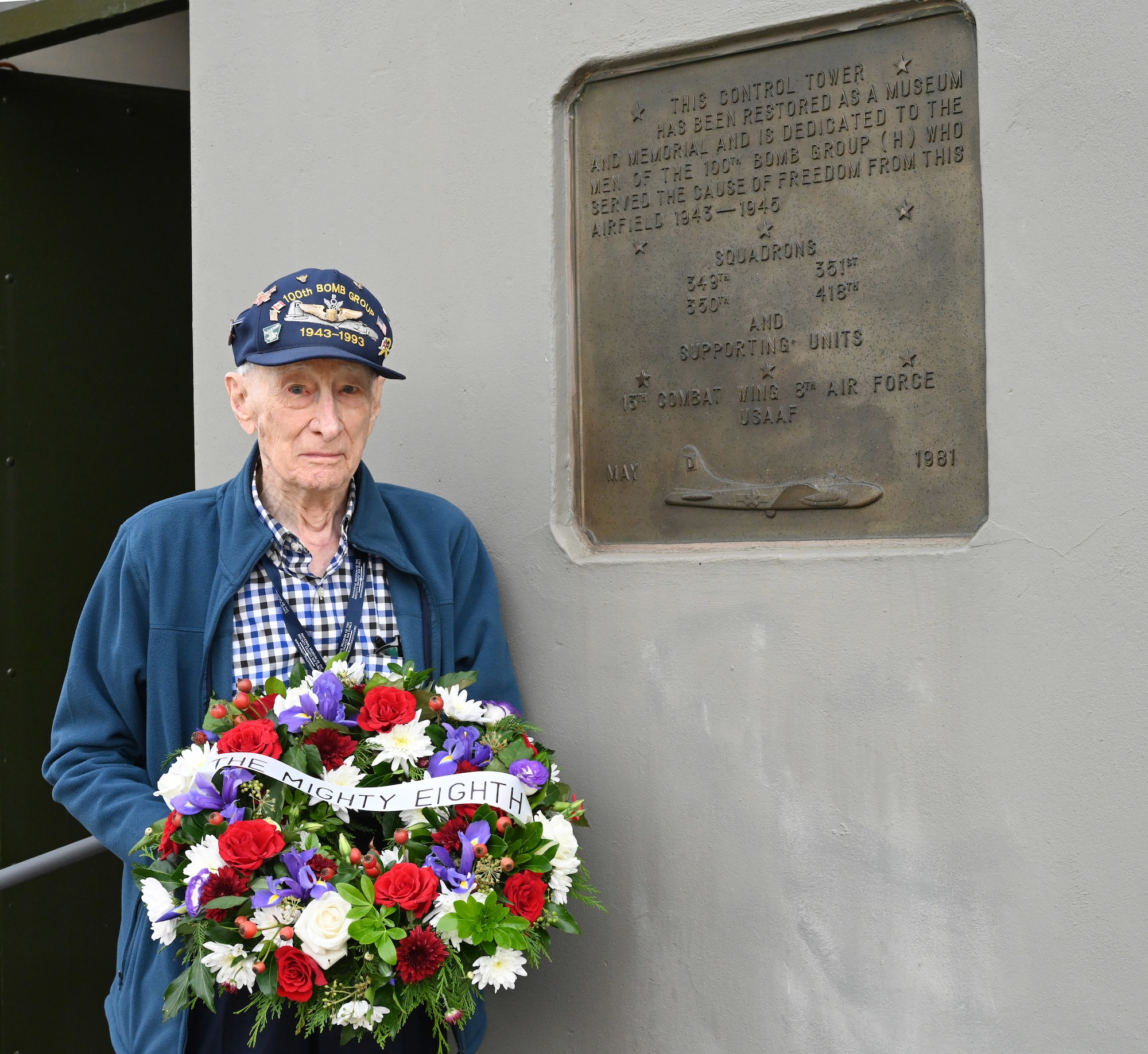 U.S. Army Air Force retired-Maj. John “Lucky” Luckadoo, legendary World War II B-17 pilot and 100th Bomb Group veteran, prepares to lay a wreath in honor of his former friends and comrades who paid the ultimate sacrifice during World War II, near plaques on the wall of the control tower during a ceremony honoring the 80th anniversary of “Black Week” at the 100th BG Memorial Museum at Thorpe Abbotts, Norfolk, England, Oct. 10, 2023. During “Black Week,” the Mighty Eighth lost 138 heavy bombers, 24 fighters and more than 1,400 Airmen to enemy action. The 100th BG itself suffered the tragic loss of 12 aircraft and 121 crew members over Germany. (U.S. Air Force photo by Karen Abeyasekere)
