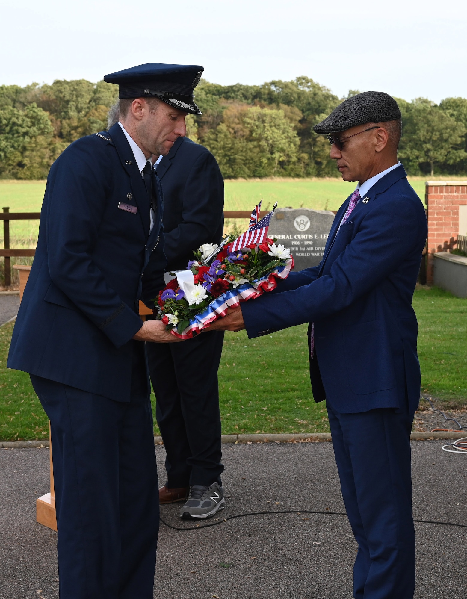 U.S. Air Force Col. Ryan Garlow, left, 100th Air Refueling Wing commander, prepares to lay a wreath on behalf of the Bloody Hundredth at Royal Air Force Mildenhall, and in honor of his step-grandfather, Tech. Sgt. James P. Scott Jr., who was assigned with the 100th Bomb Group during World War II, during a ceremony to remember the 80th anniversary of “Black Week” at Thorpe Abbotts, Norfolk, England, Oct. 10, 2023. During “Black Week,” the Mighty Eighth lost 138 heavy bombers, 24 fighters and more than 1,400 Airmen to enemy action. The 100th BG itself suffered the tragic loss of 12 aircraft and 121 crew members over Germany. (U.S. Air Force photo by Karen Abeyasekere)