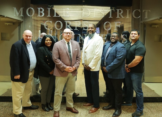 From left to right, Chuck Walker, Keesha Robinson, Dustin Gautney, Cicone Prince, Jeremy Murray, Chris Carranza, Mobile District’s Public Affairs team pose for a photo at the District headquarters in Mobile, Alabama, October 17, 2023.  Public Affairs is responsible for ensuring that the public is informed about the U.S. Army Corps of Engineers’ activities, priorities, and policies through various communication mediums, such as news and social media. (U.S. Army photo by Jeremy Murray)