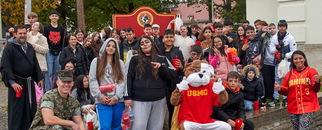 Students from Echendorffschule pose for a group photo during the annual Trunk or Treat event on Panzer Kaserne, Boeblingen-Stuttgart, Germany, Oct. 19, 2023. The annual Trunk or Treat Halloween celebration presents an opportunity to bring Marines, Sailors and families together to build relationships and camaraderie. The event also presents an opportunity to increase local community engagement and outreach by the U.S. Marine Corps Forces, Europe and Africa Headquarters. (U.S. Marine Corps photo by Lance Cpl. Maxwell Cook)