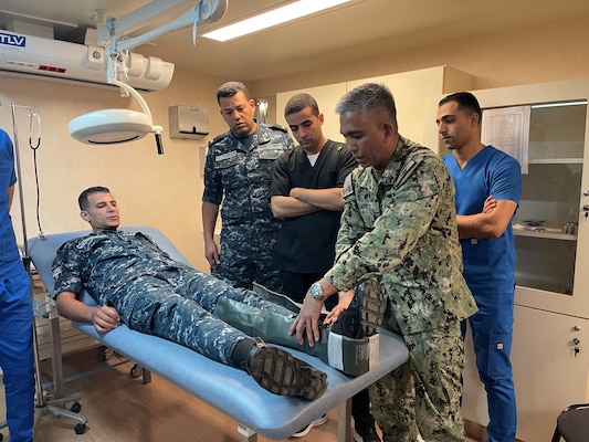 Senior Chief Hospital Corpsman Louie Bismonte, right, demonstrates proper splinting techniques with Egyptian doctors and nurses during a Tactical Combat Casualty Care (TCCC) course for exercise Bright Star 23 aboard Egyptian Naval Ship (ENS) Anwar El-Sadat at Ras Al Tin Naval Forces Base, Egypt, Sept. 11.