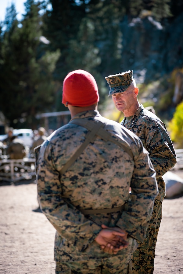 U.S. Marine Corps Maj. Gen. Thomas B. Savage, commanding general of Marine Air-Ground Task Force Training Command, Marine Corps Air-Ground Combat Center, right, speaks with Staff Sgt. Jovanny Duran, a Las Vegas, Nevada native, mountain warfare instructor assistant team leader for Marine Corps Mountain Warfare Training Center, while visiting a training site during Mountain Exercise 1-24 at MCMWTC, Bridgeport, California, Oct. 11, 2023. Compared to more generalized training facilities, MCMWTC specializes in mountain warfare training, providing a unique and ideal opportunity to rehearse operations in a mountainous environment. (U.S. Marine Corps photo by Lance Cpl. Richard PerezGarcia)