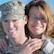 Man in uniform and woman pose in a close-up photo together.